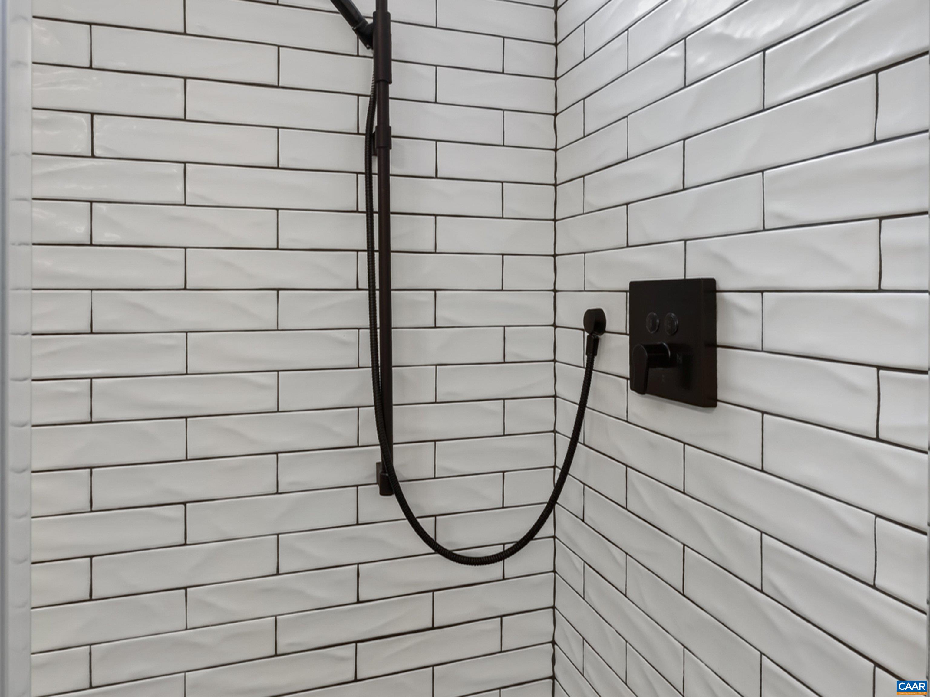 Tiled shower with glass doors. Tiled shower with glass doors.