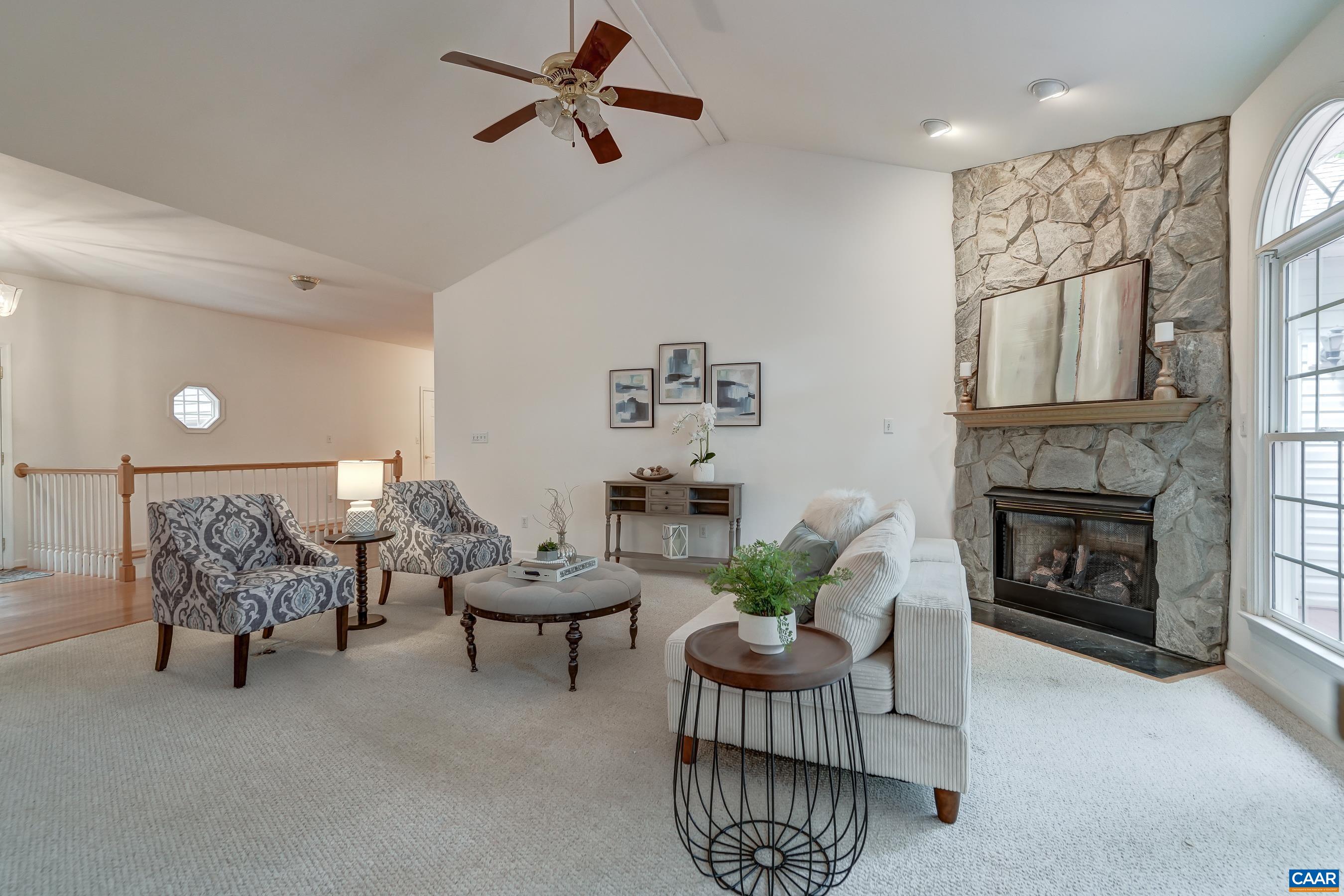 Vaulted great room with gas fireplace and stone accent surround. Vaulted great room with gas fireplace and stone accent surround.