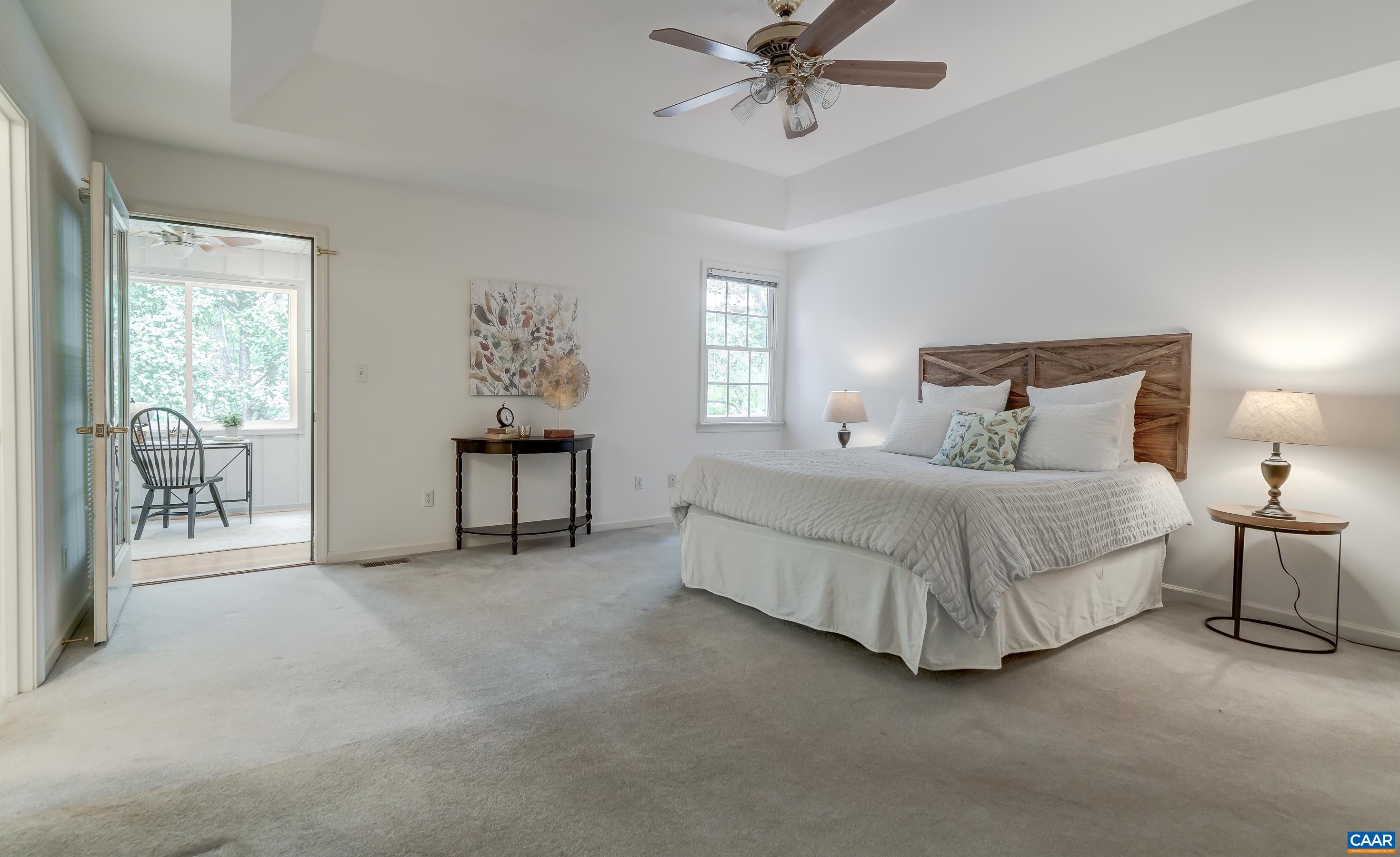 Main level primary suite features walk in closet, ensuite bathroom and private home office/studio Main level primary suite features walk in closet, ensuite bathroom and private home office/studio