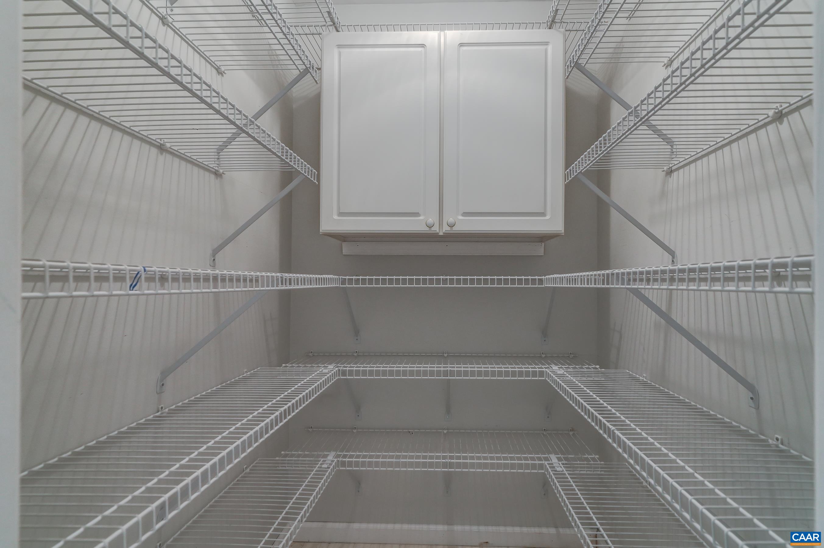 Large walk in primary closet. Large walk in primary closet.