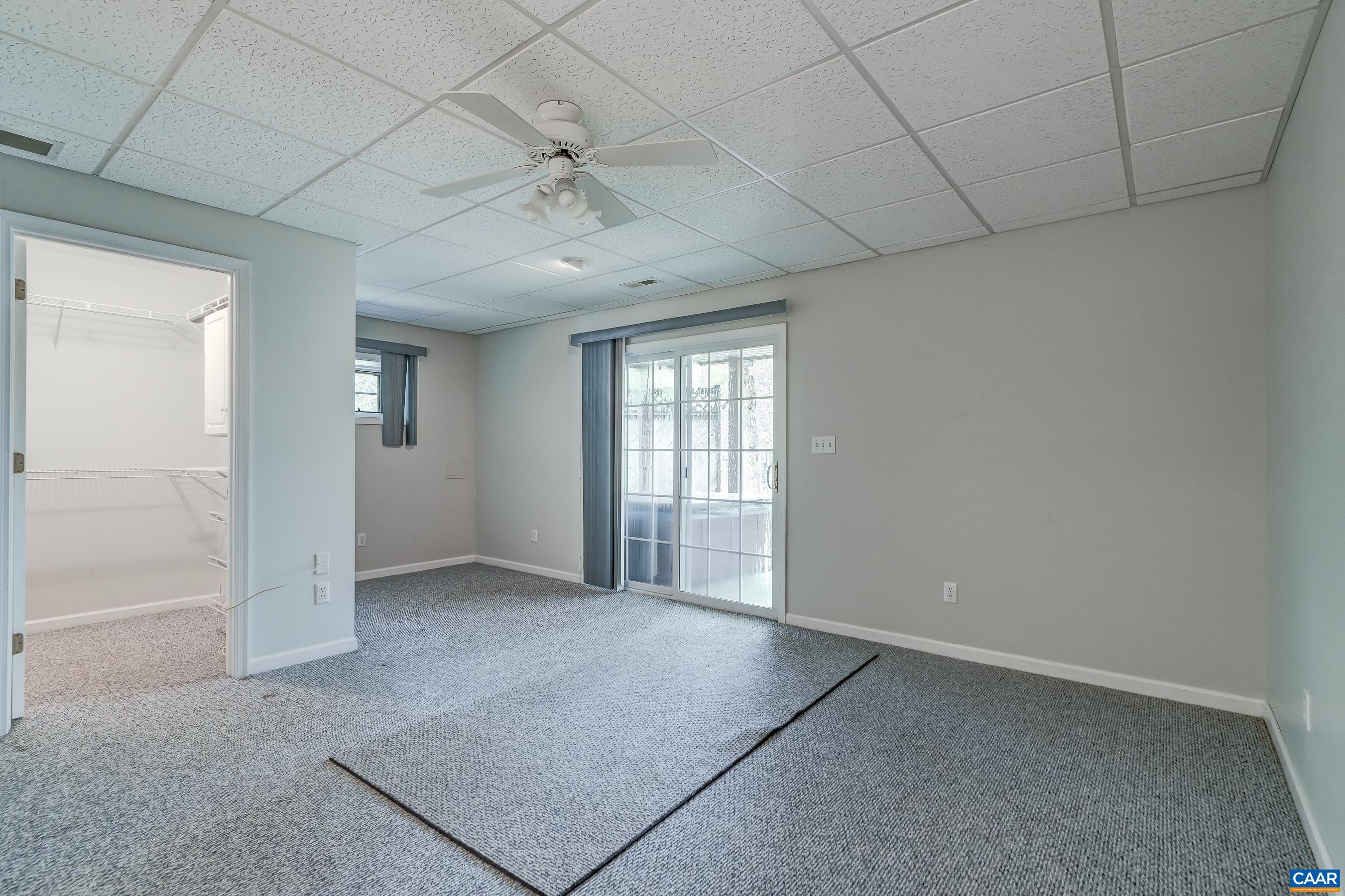 Lower level bedroom with sliding door to patio and walk-in closet. Lower level bedroom with sliding door to patio and walk-in closet.