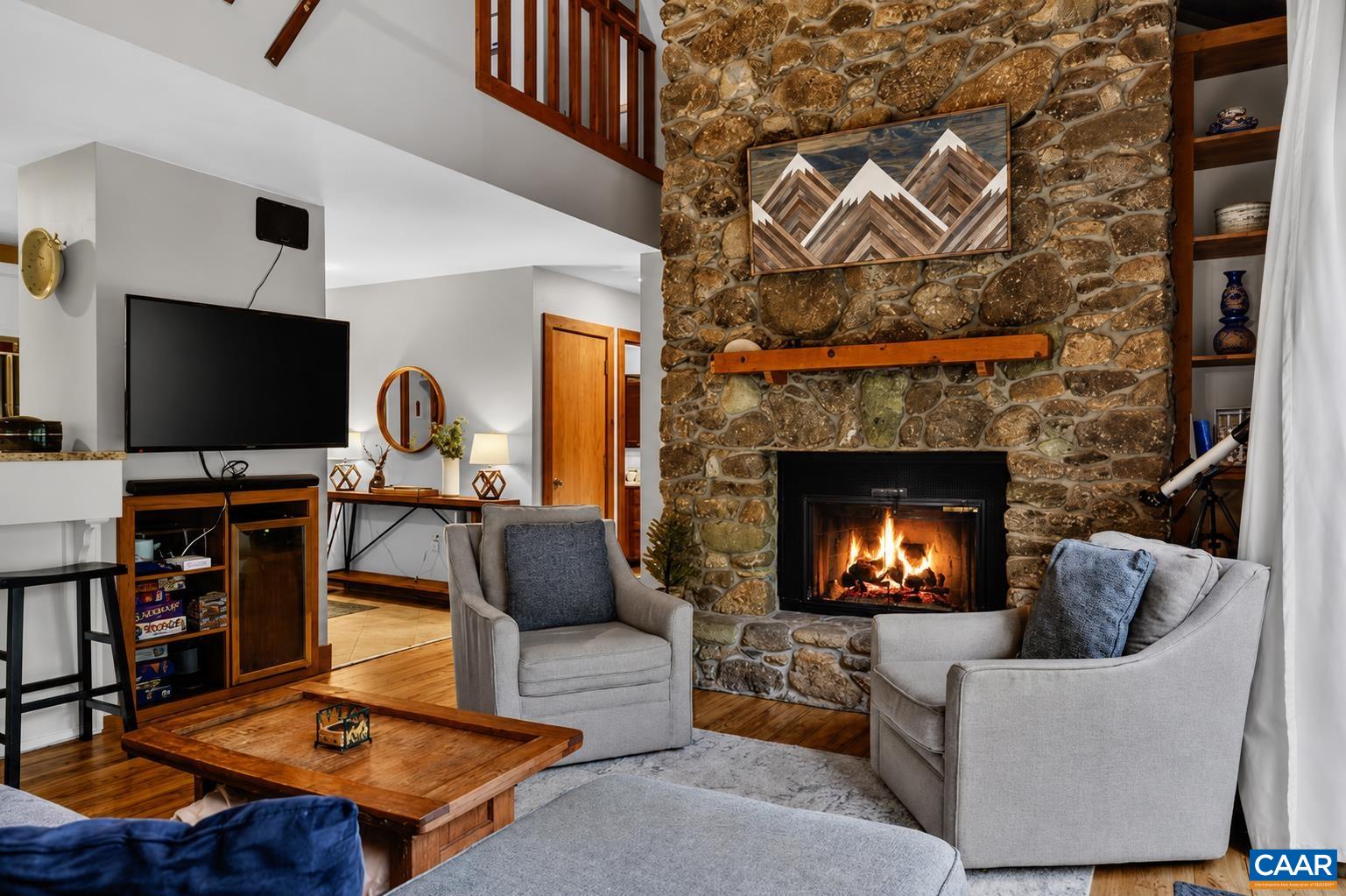 Stunning floor to ceiling stone wood burning fireplace is the focal point of the great room. Stunning floor to ceiling stone wood burning fireplace is the focal point of the great room.