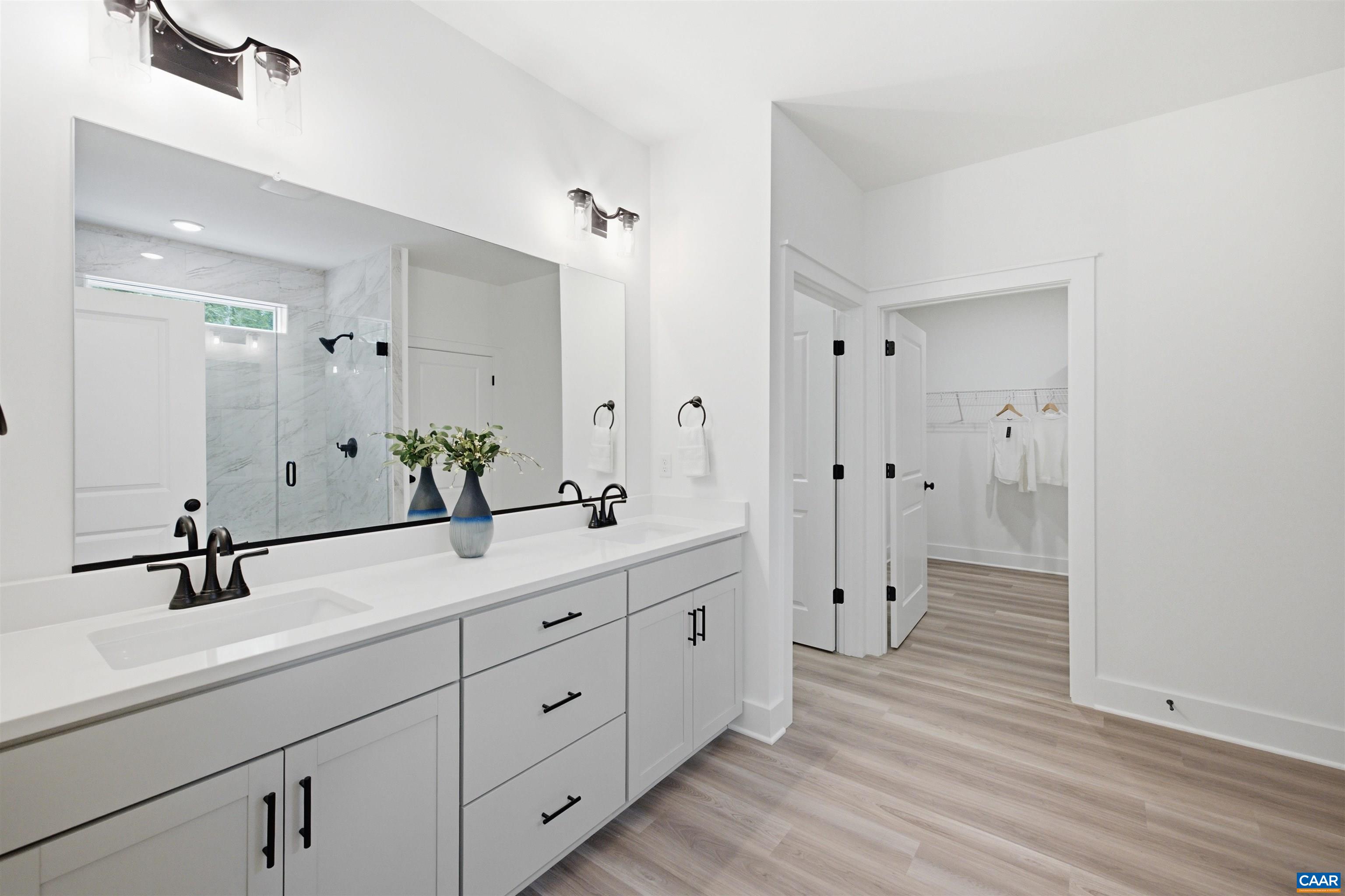 Dual Vanities, view to walk-in closet and private water closet. Staged home. Dual Vanities, view to walk-in closet and private water closet. Staged home.