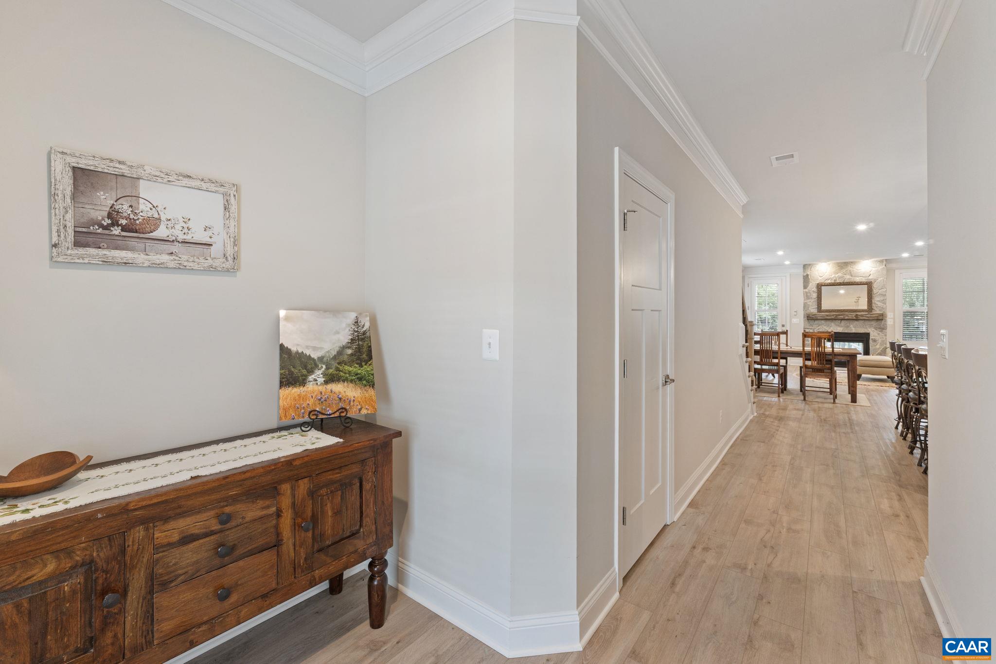 Looking into the home from the front foyer. Half bath on left.
