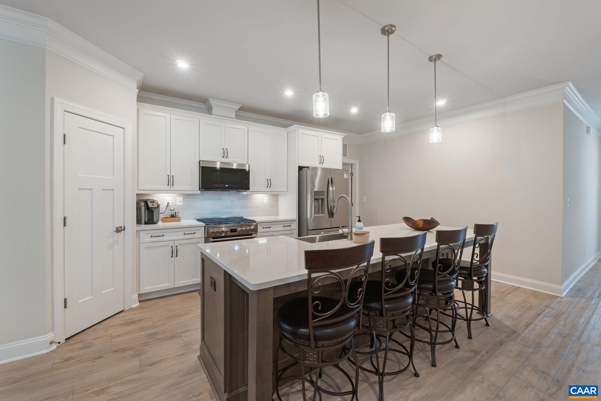 Pantry with mudroom, laundry, and garage door to the right.
