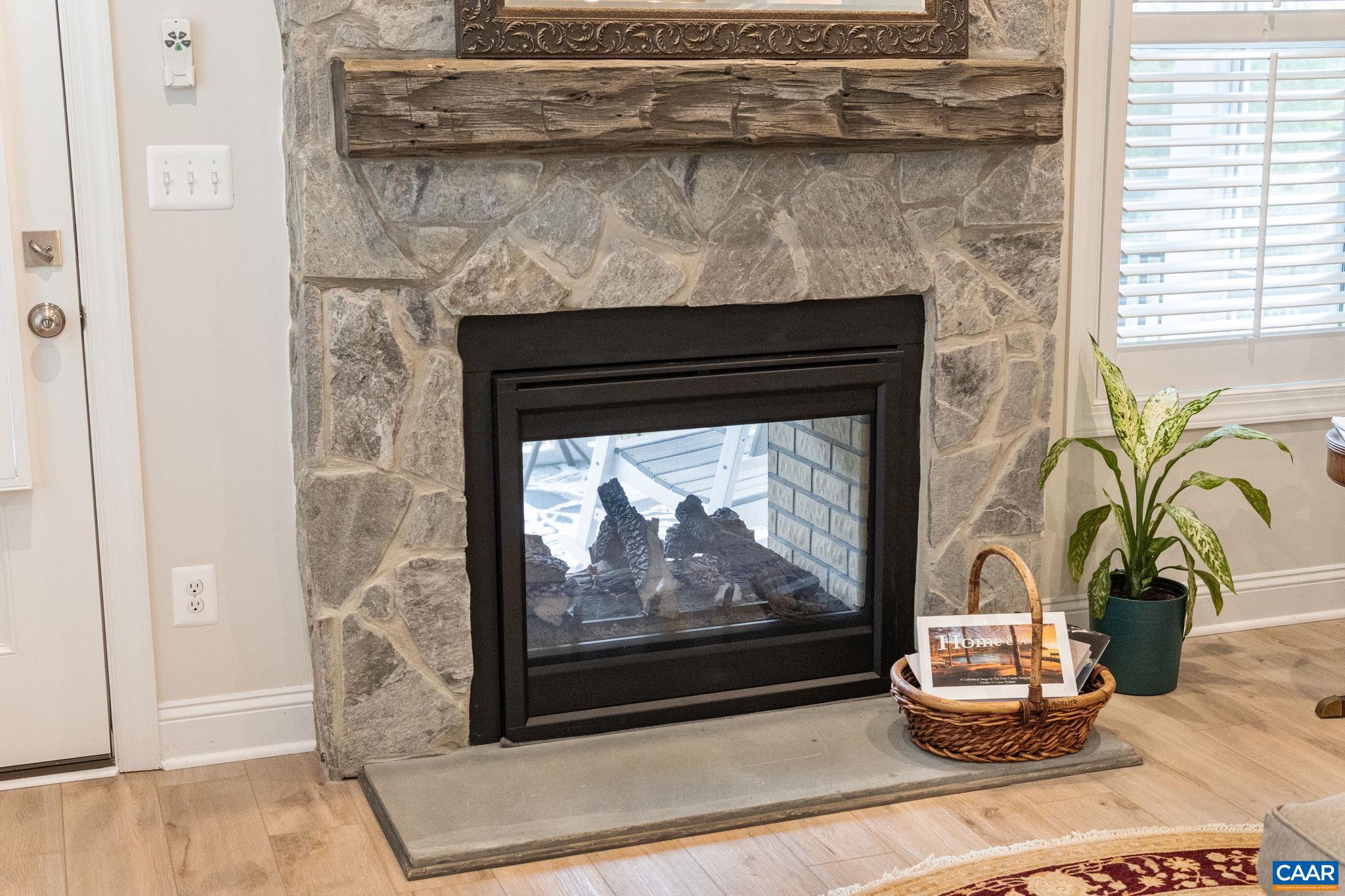 See through fireplace with floor to ceiling stone surround.
