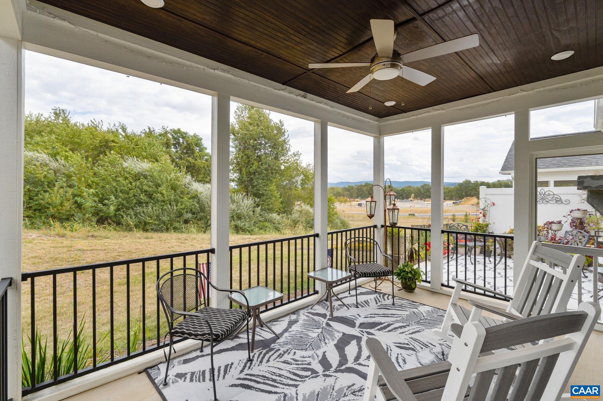 Screen porch with ceiling fan and mountain views.
