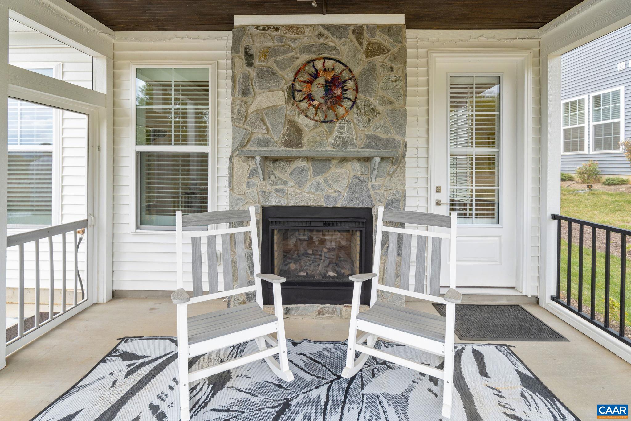 See through fireplace with floor to ceiling stone surround.