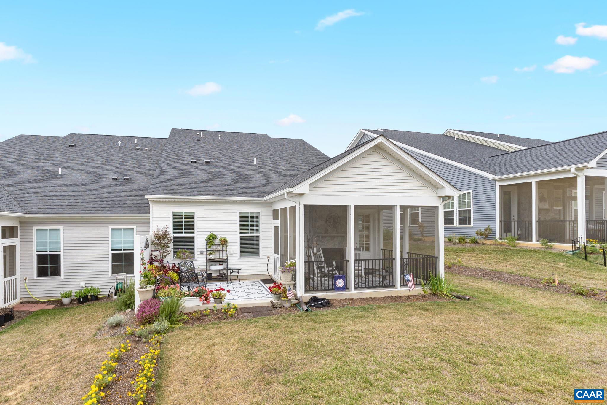 Rear of home with patio and screened porch.