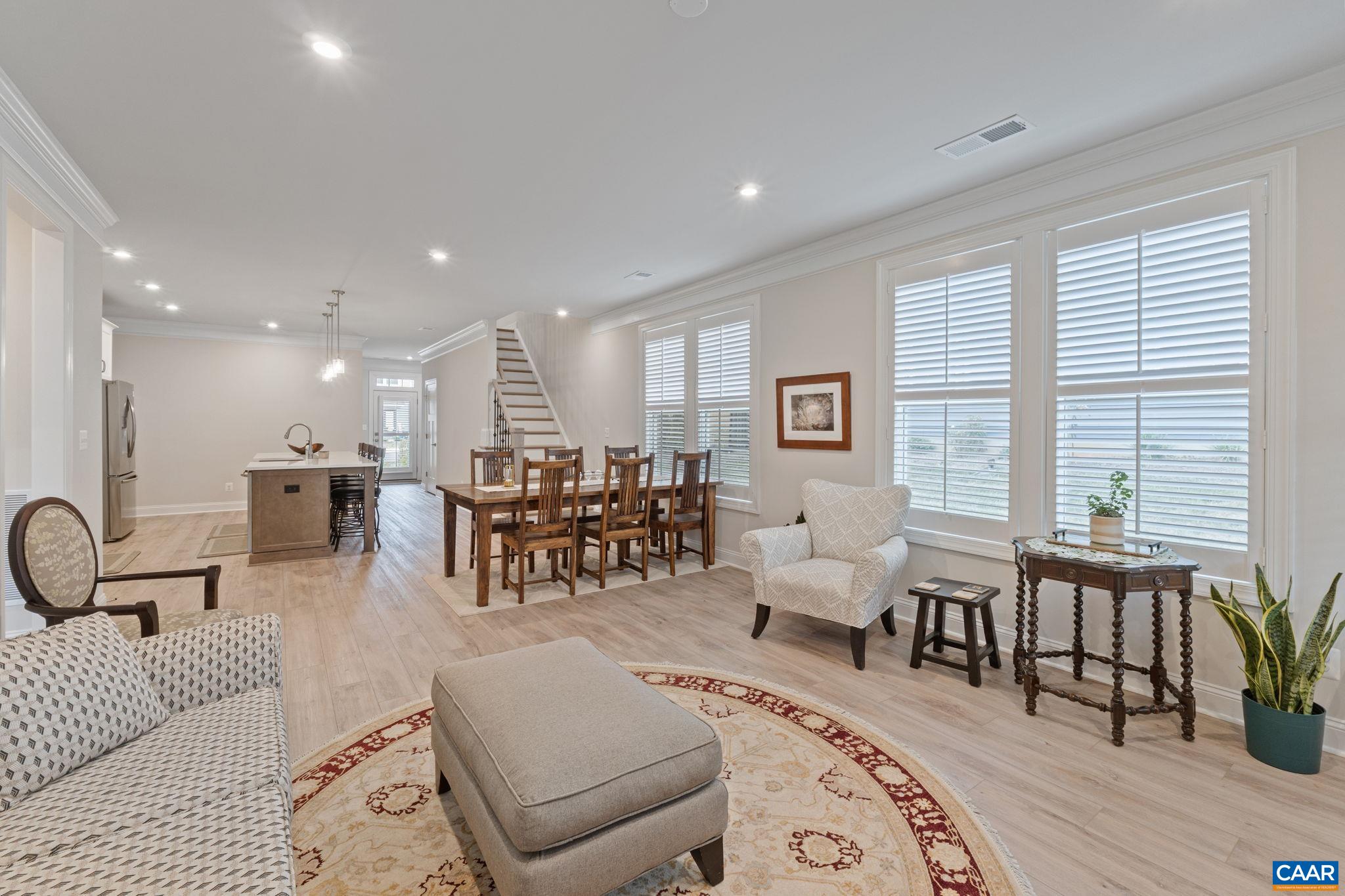 Dining area, plantation shutters and stairs leading up.