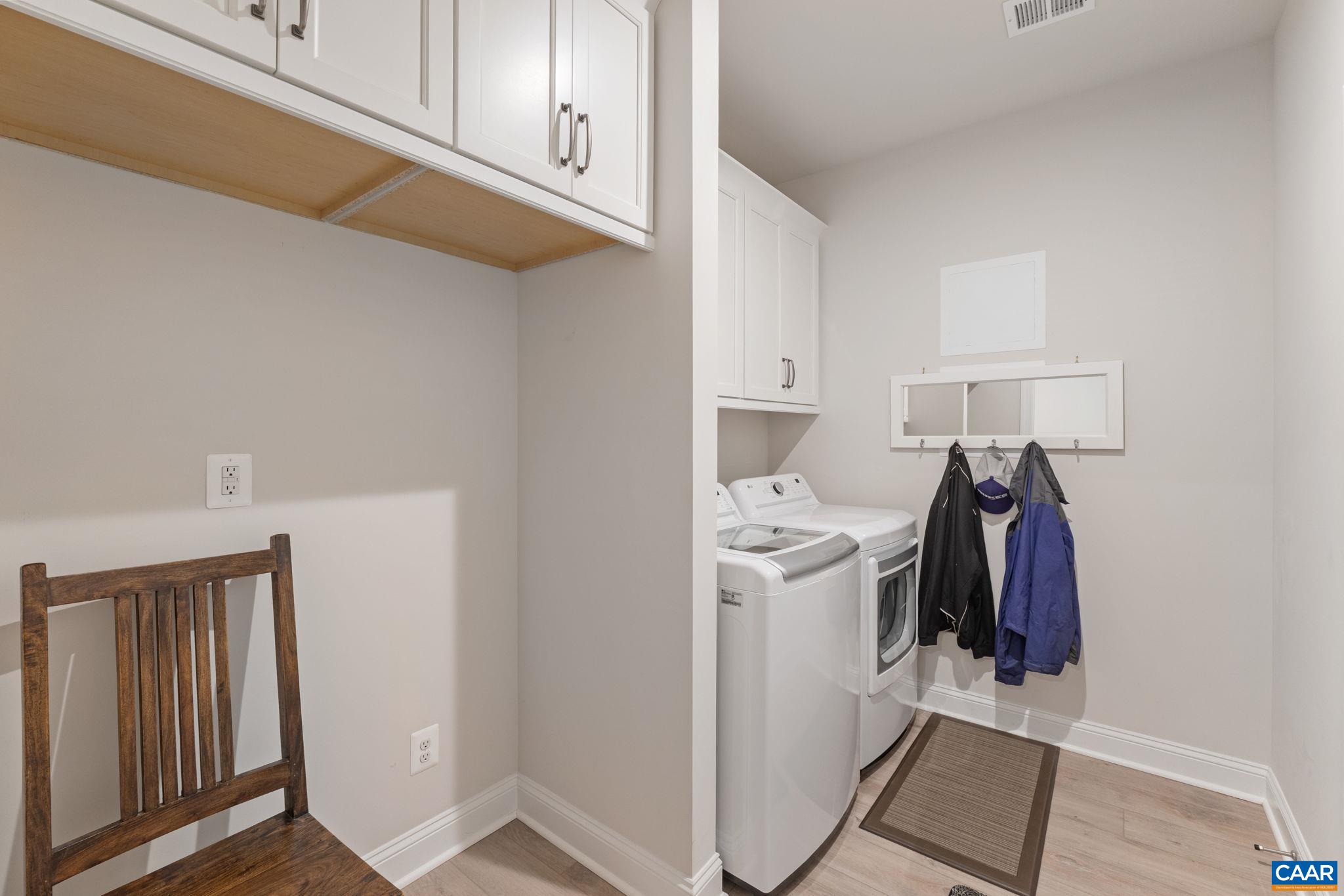 Mud room with built-ins, laundry, and garage access.