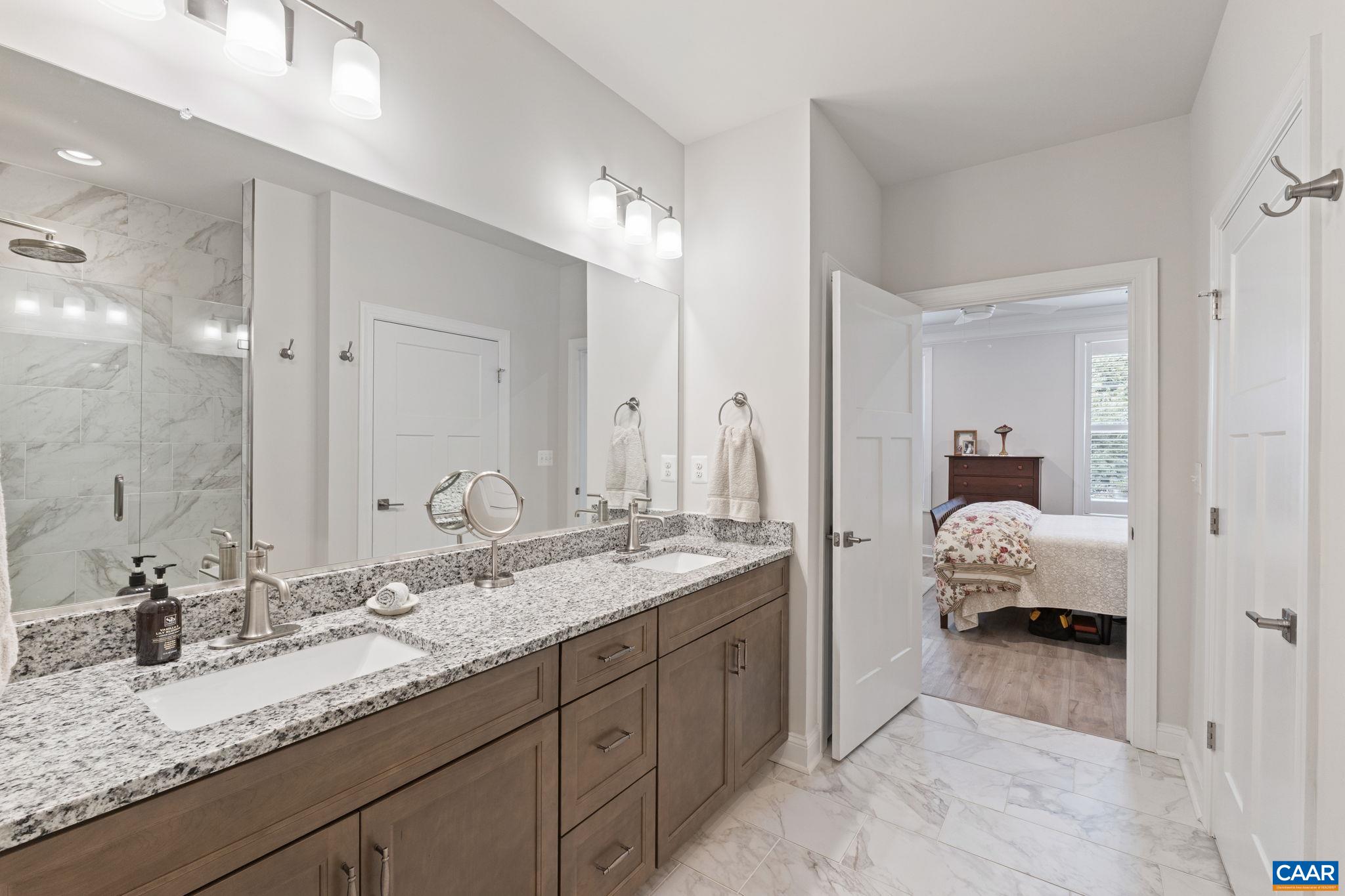 Fully tiled primary bathroom.