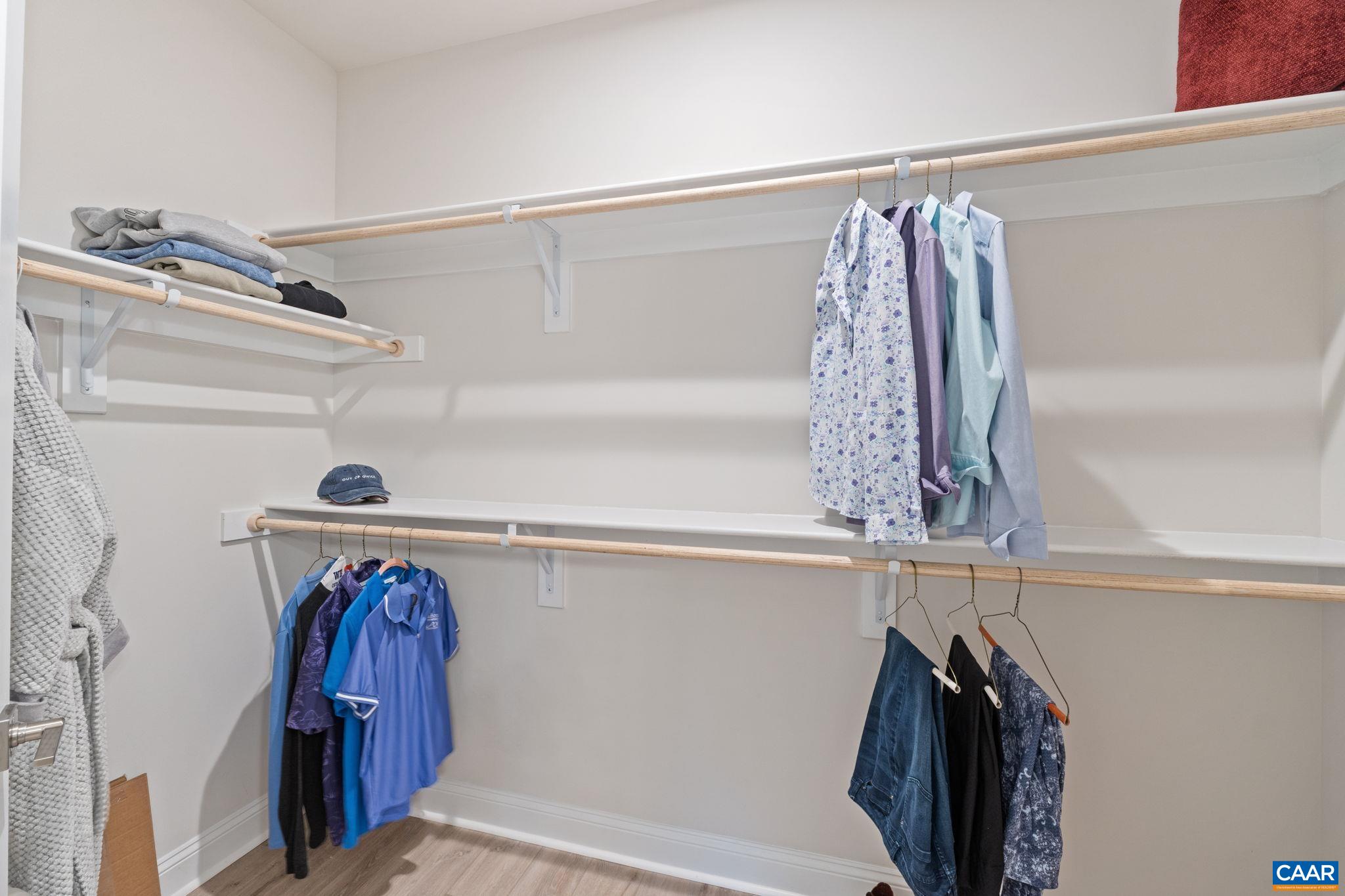Large walk in primary closet with wood sheving.