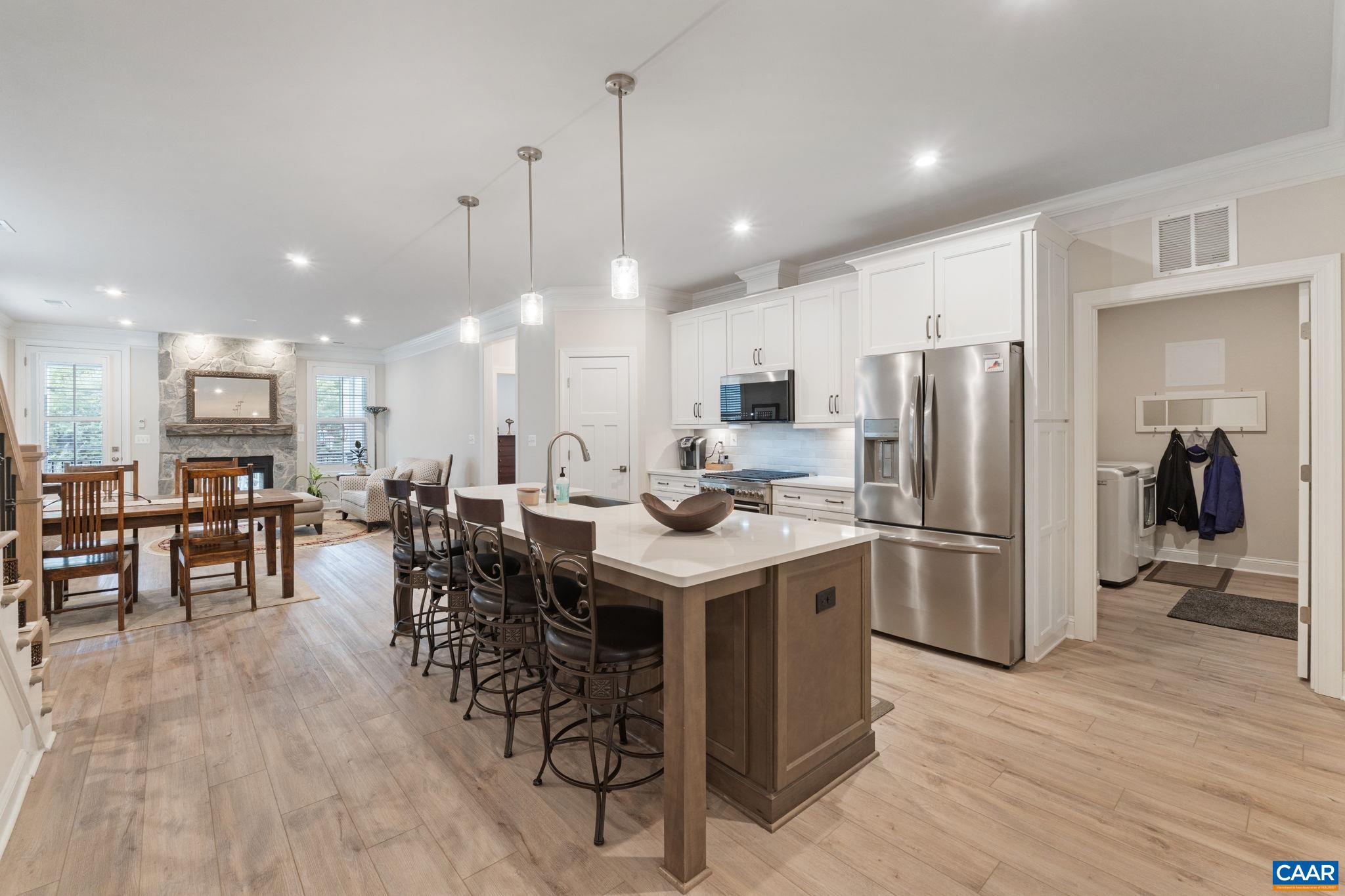 Stunning chef's kitchen with granite counters and white cabinetry.