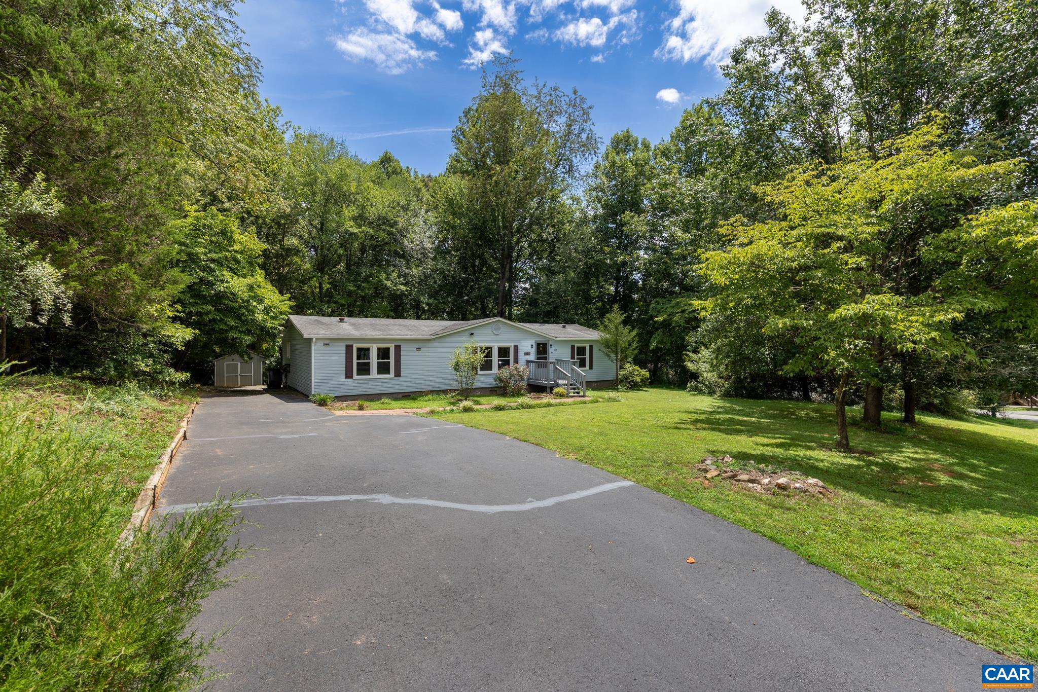 Welcome home! A spacious paved driveway leads to this single-story gem tucked away on a lush, tree-lined lot. Enjoy plenty of parking, beautiful natural surroundings, and quiet privacy in a peaceful setting with great curb appeal.