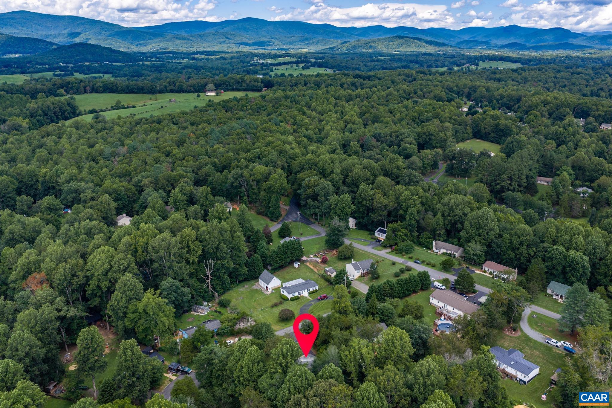 Stunning aerial perspective pinpointing this desirable property! Nestled in a quiet neighborhood surrounded by dense green canopy and picturesque mountain views, it offers the ultimate combination of serene privacy and natural beauty.