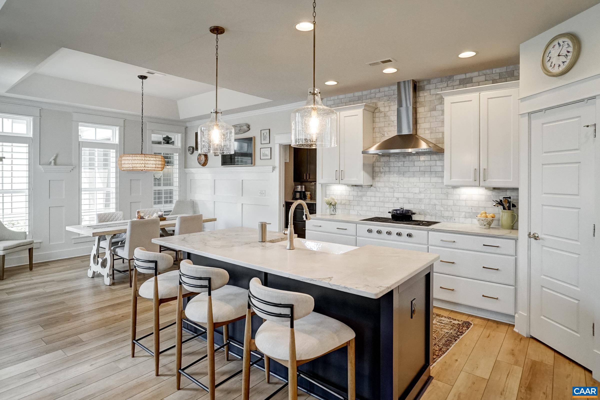 Gourmet kitchen features white cabinets, leathered granite countertops and high-end appliances. Gourmet kitchen features white cabinets, leathered granite countertops and high-end appliances.