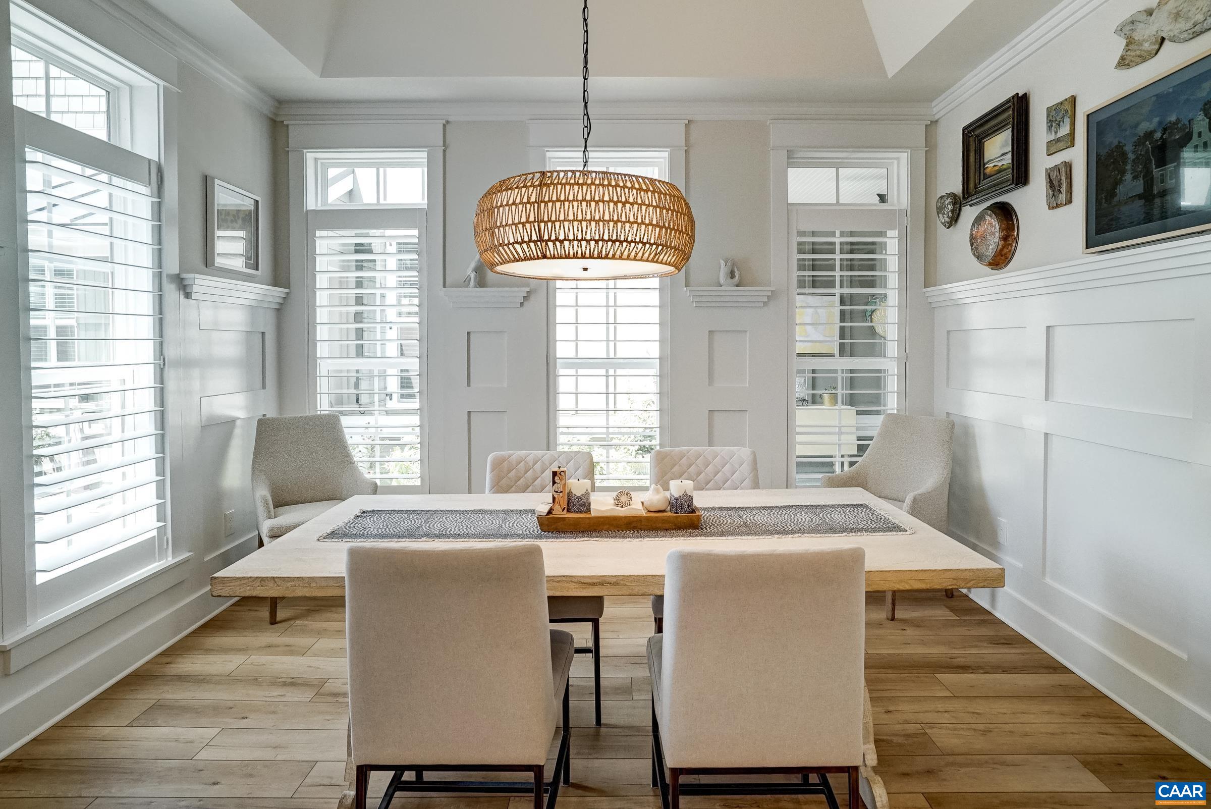 Dining area with wainscotting and new light fixture. Dining area with wainscotting and new light fixture.