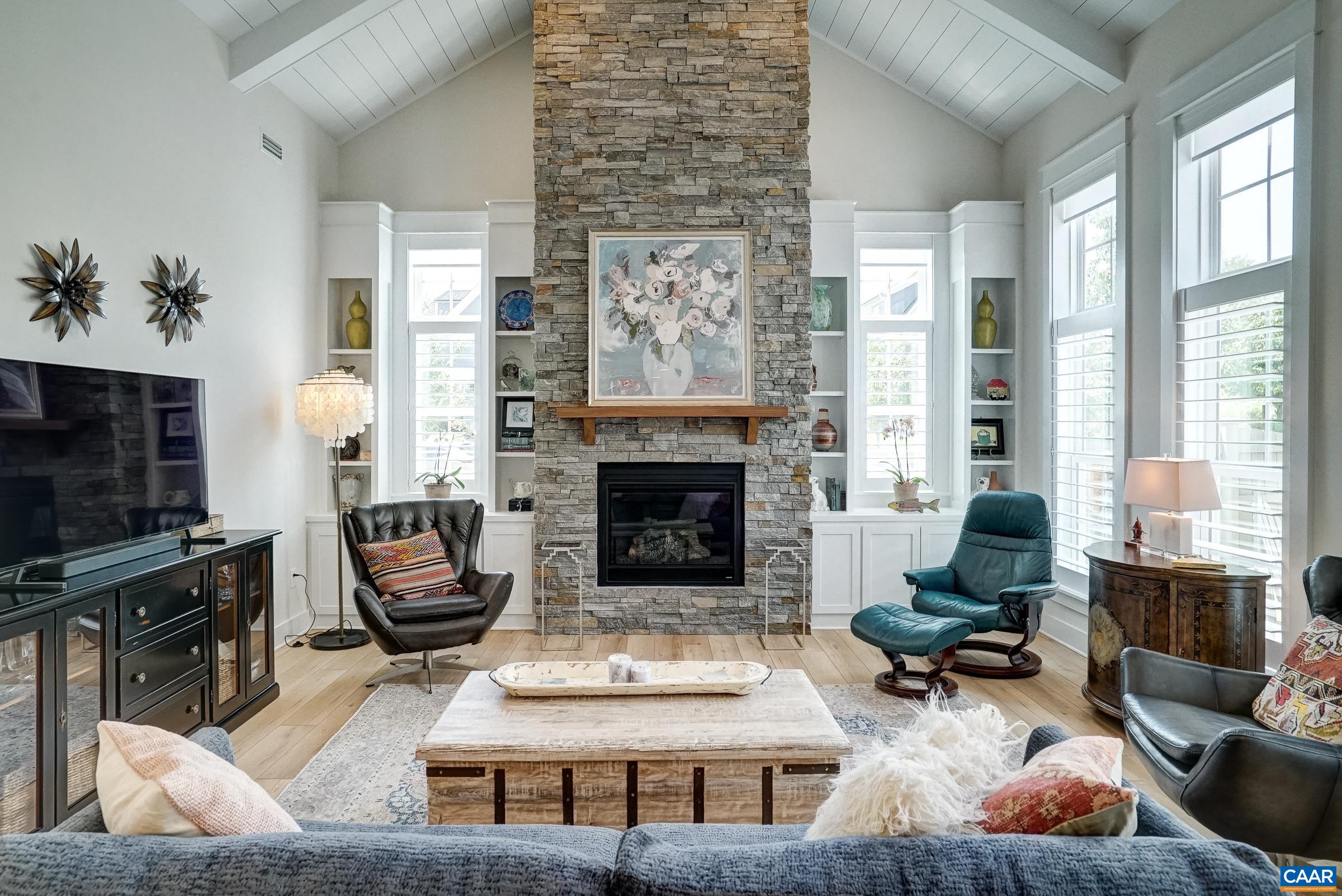 Stacked stone fireplace with built-ins in the vaulted great room. Stacked stone fireplace with built-ins in the vaulted great room.