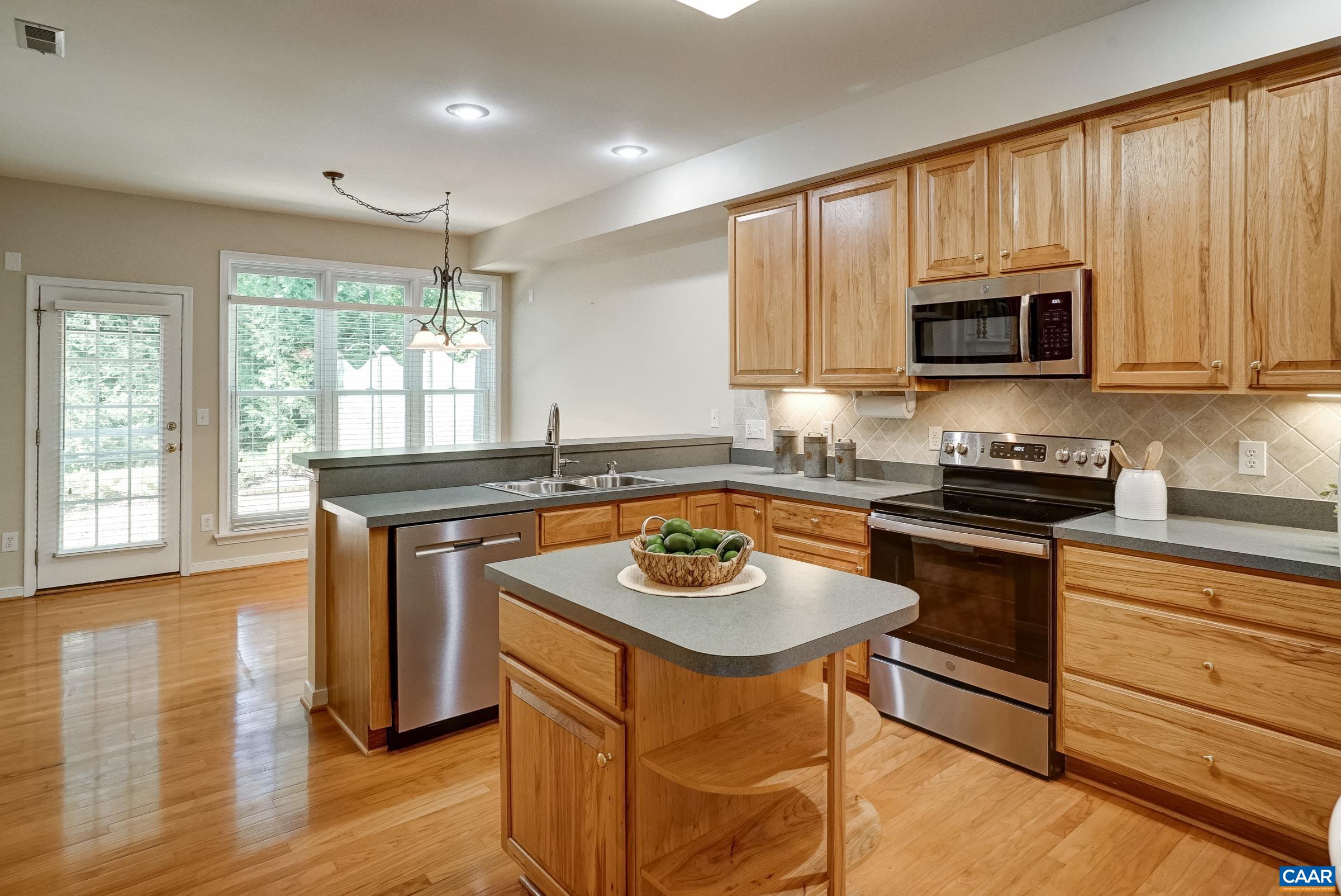 Practical and polished kitchen with maple cabinets Practical and polished kitchen with maple cabinets