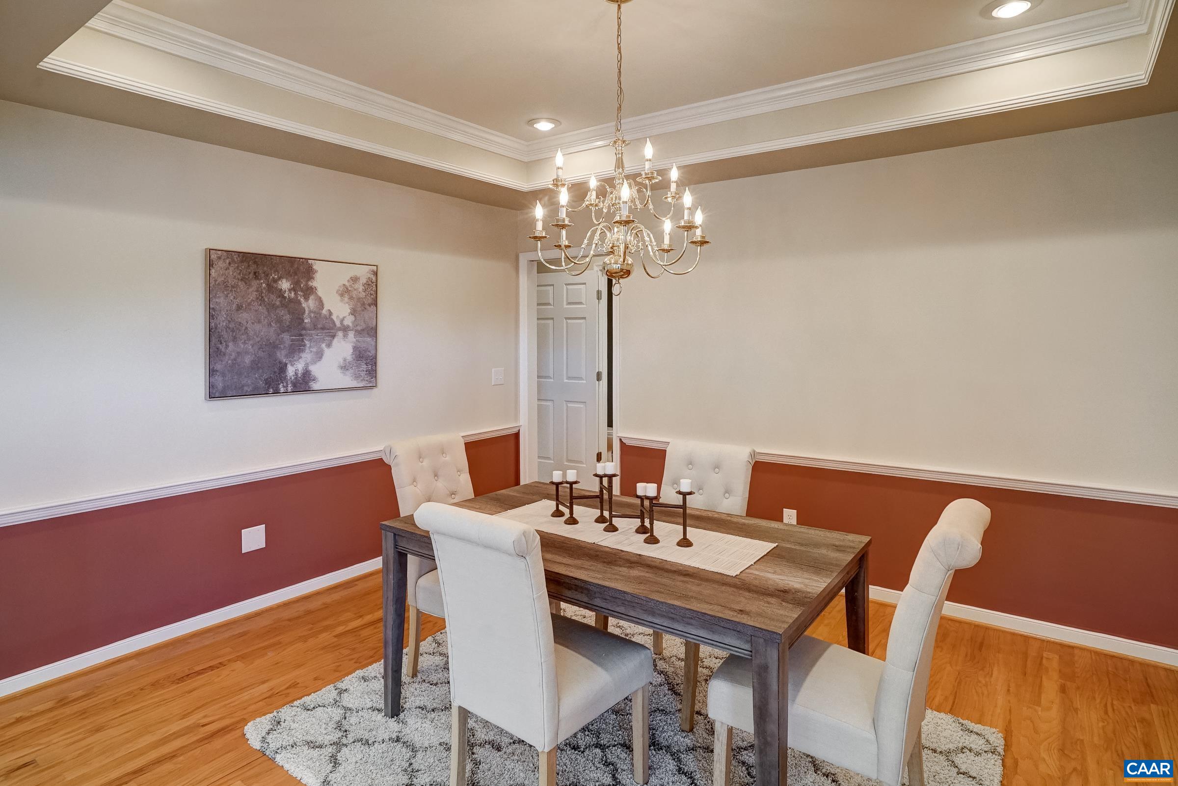 Formal dining room features chair rail and tray ceilng. Formal dining room features chair rail and tray ceilng.