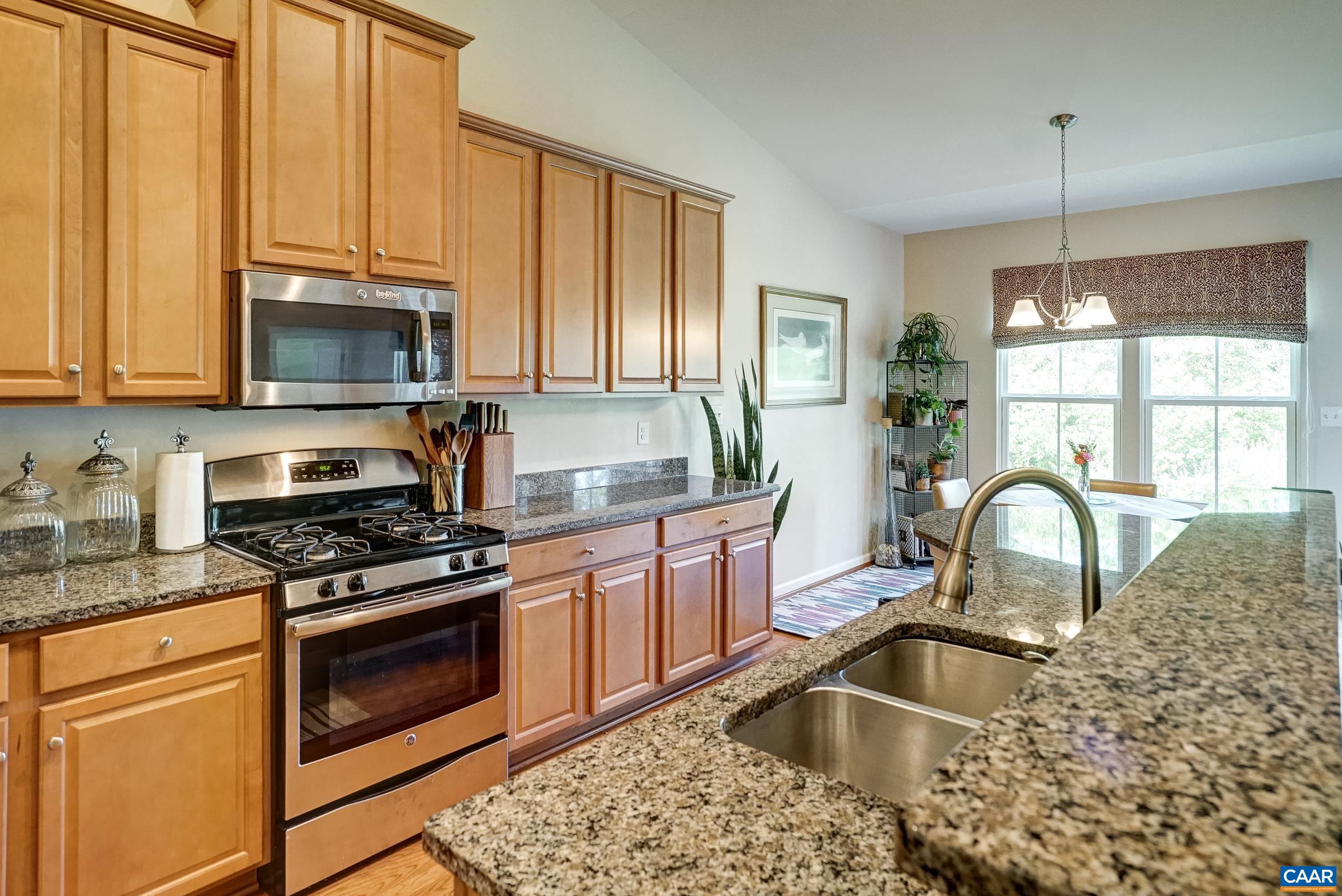 Maple cabinets and granite countertops in the gourmet kitchen. Maple cabinets and granite countertops in the gourmet kitchen.