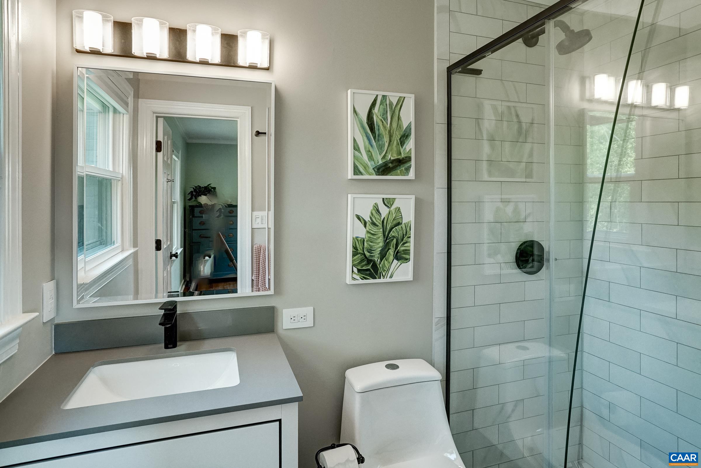Updated primary bathroom with modern tiled shower. Updated primary bathroom with modern tiled shower.