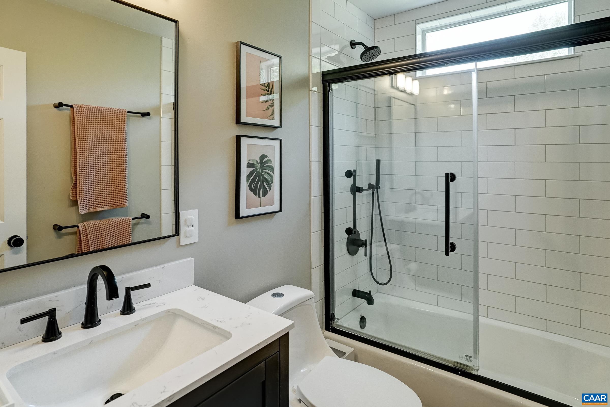 Remodeled full bathroom on second level features a tub/shower combo with sliding doors. Remodeled full bathroom on second level features a tub/shower combo with sliding doors.