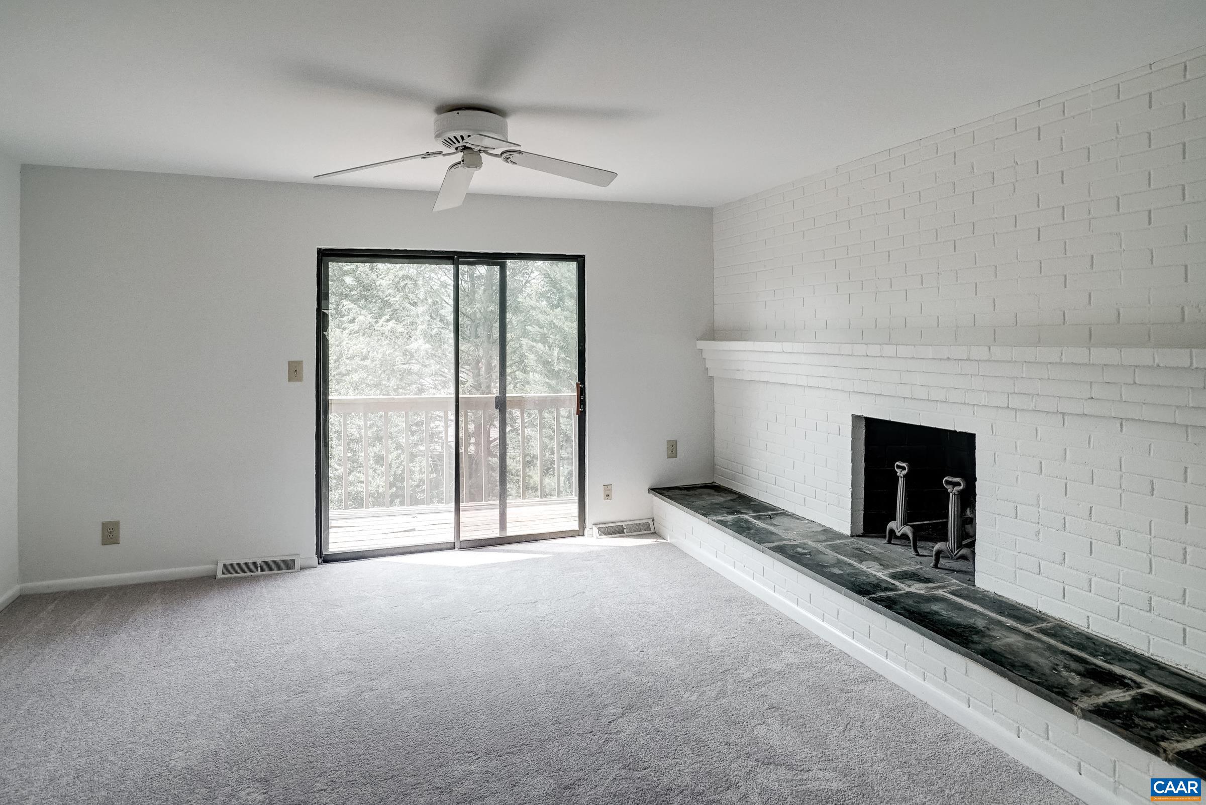 Primary bedroom with fireplace, fan and balcony Primary bedroom with fireplace, fan and balcony