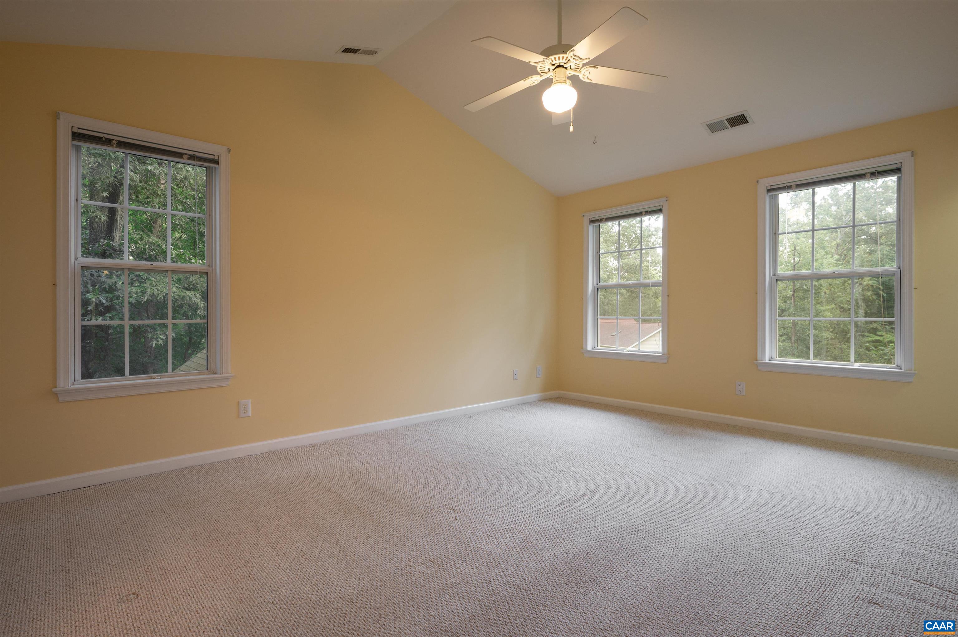 Spacious primary bedroom upstairs includes two closets and a full bath.