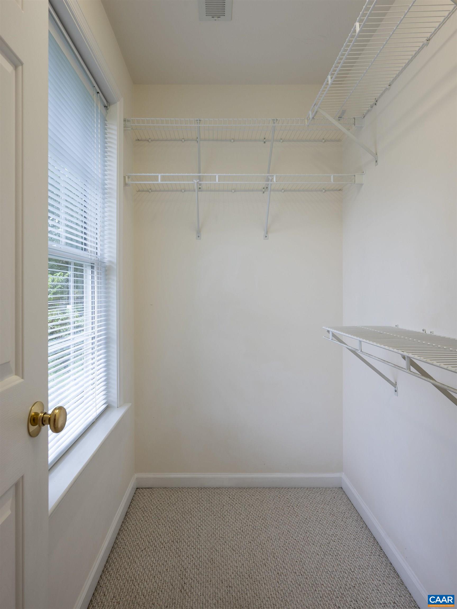 Spacious walk-in closet in primary bedroom.