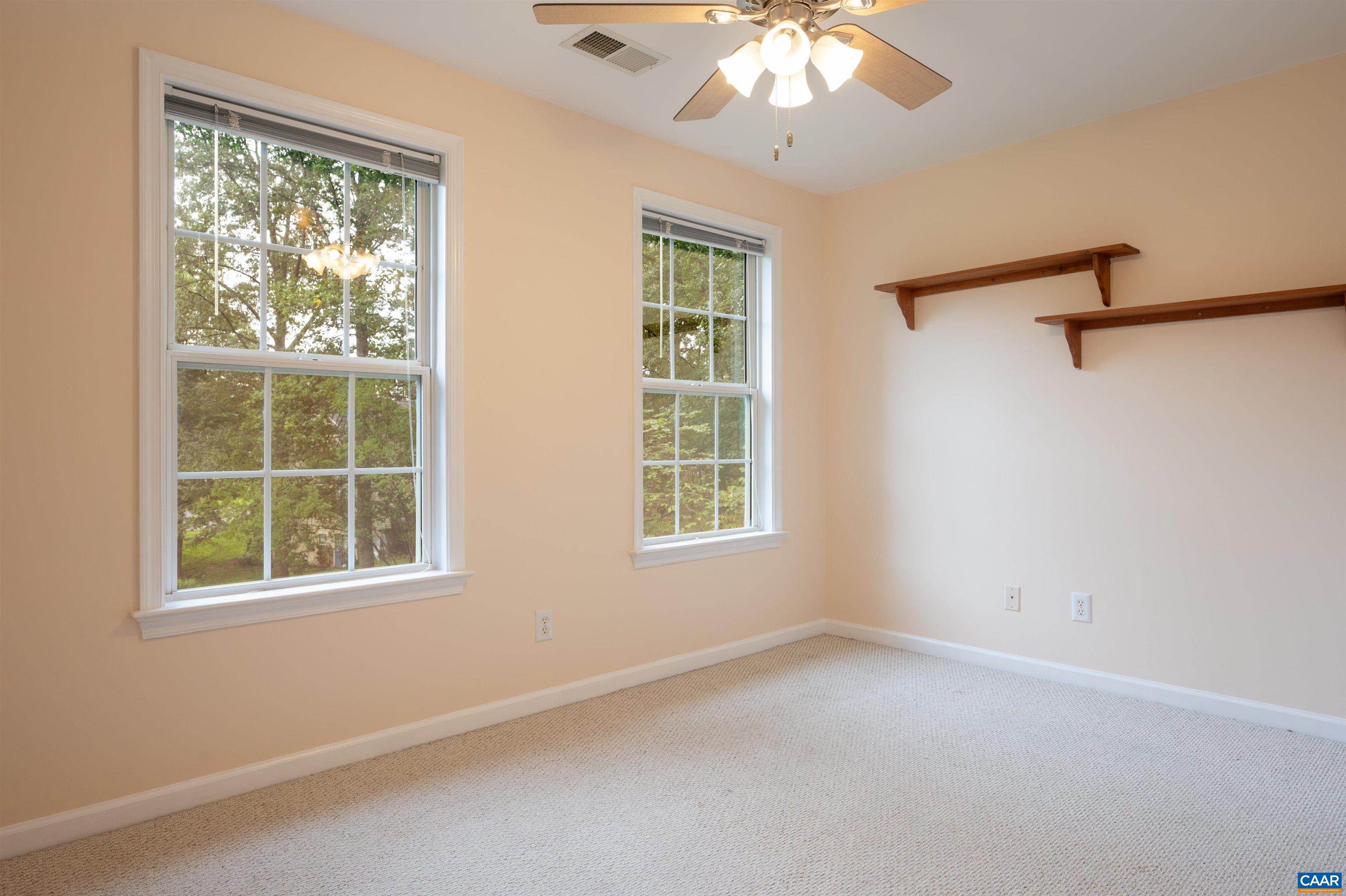 The front facing windows in this bedroom invite the morning light.