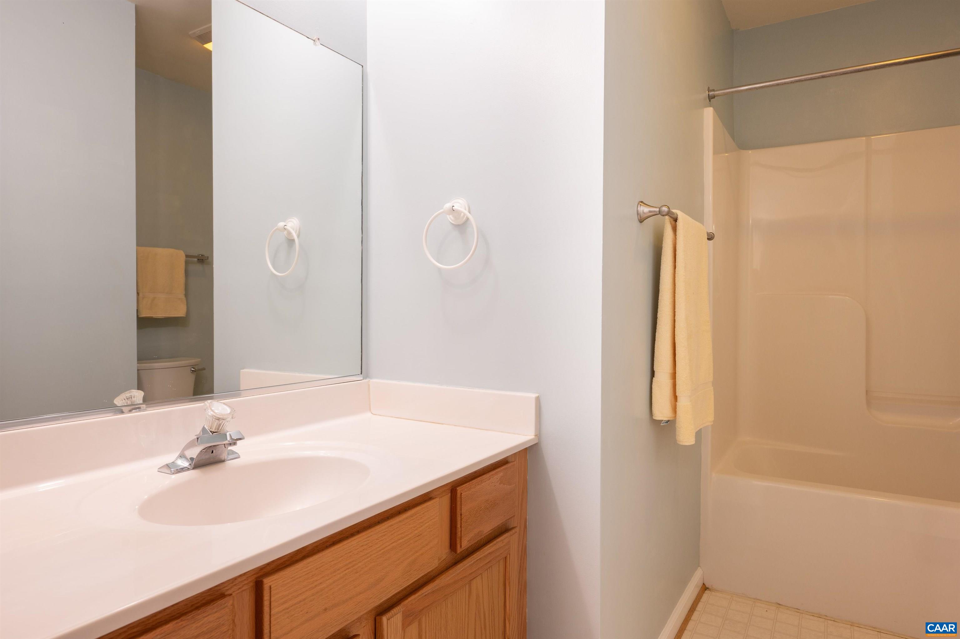 Upstairs and adjacent to the secondary bedrooms is a full bath, with linen closet and tub shower combo.