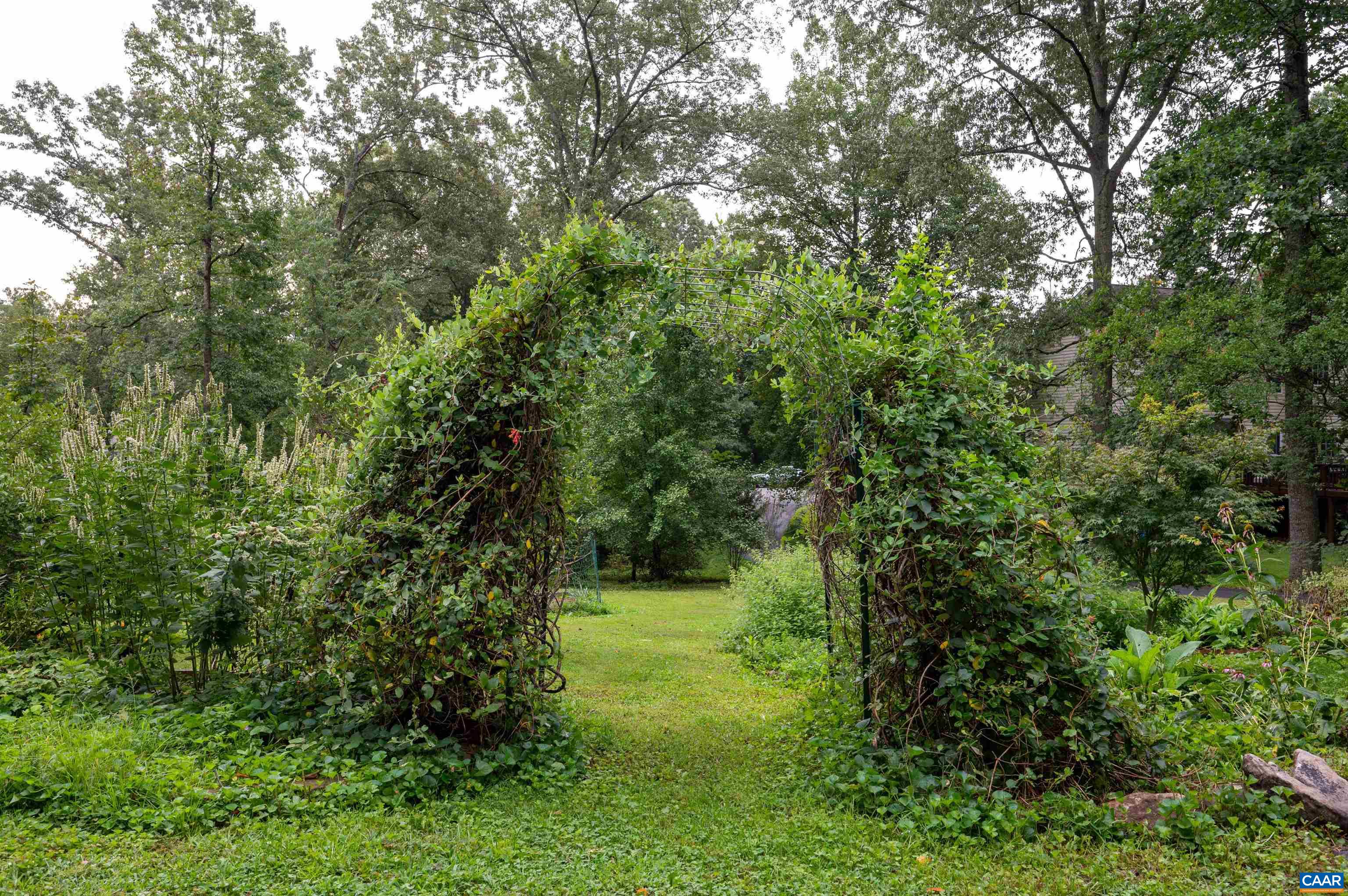 Enter the front yard into a gardener's paradise.  Filled with medicinal herbs, raised bed vegetable garden and native trees and shrubs.