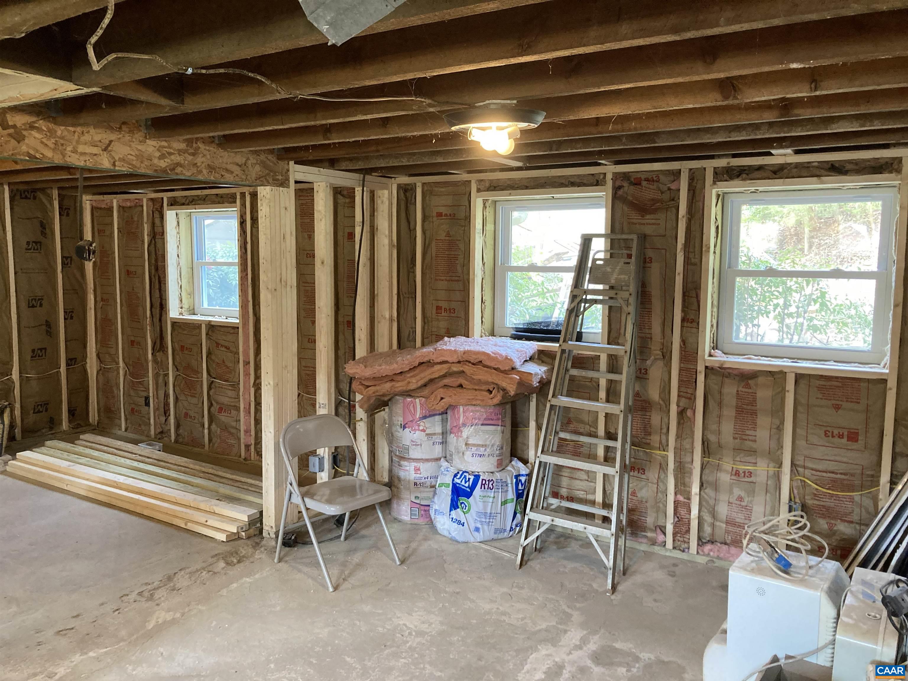 Enlarged opening between the two rooms in basement and larger new windows.