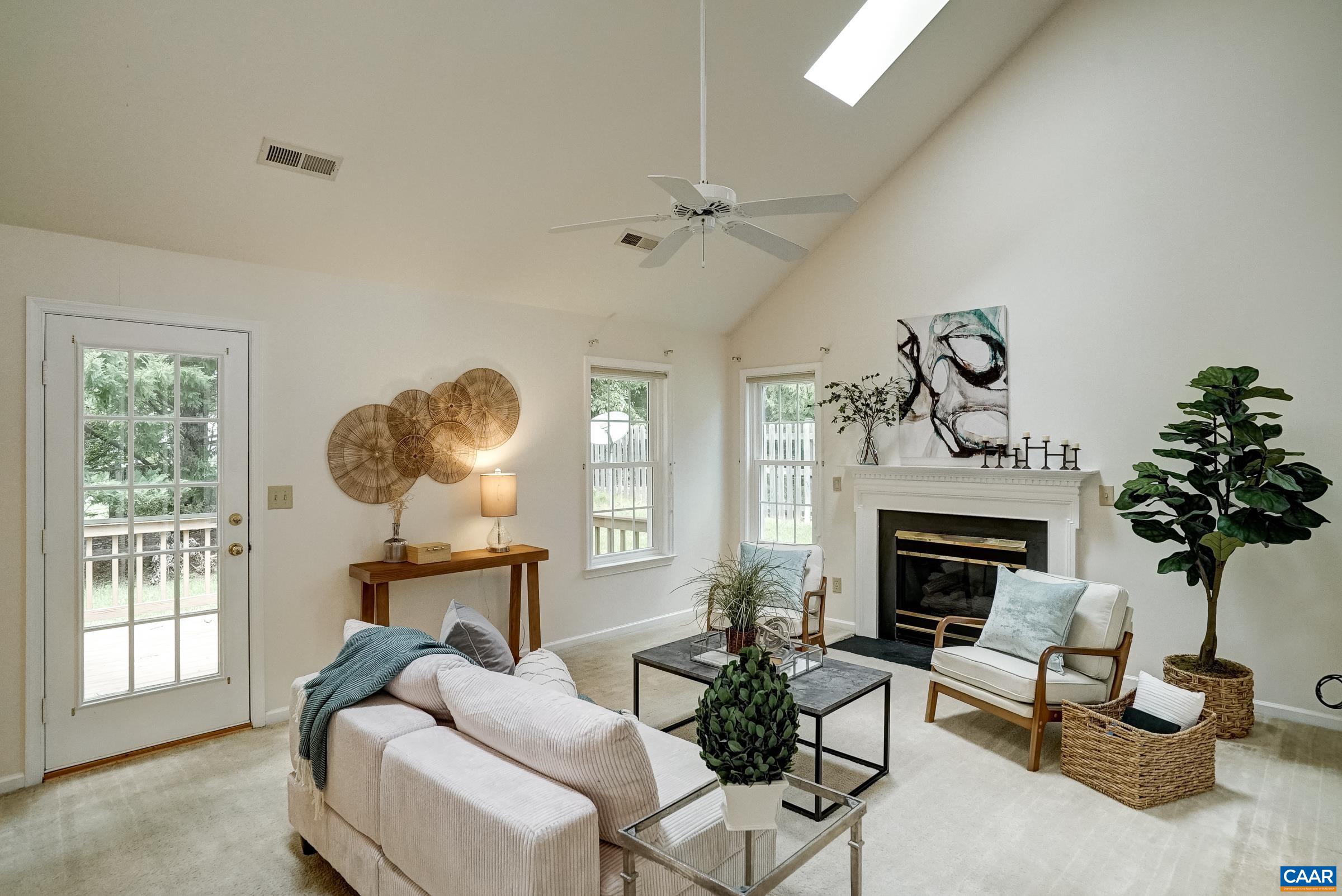 Vaulted great room with skylights and gas fireplace. Vaulted great room with skylights and gas fireplace.