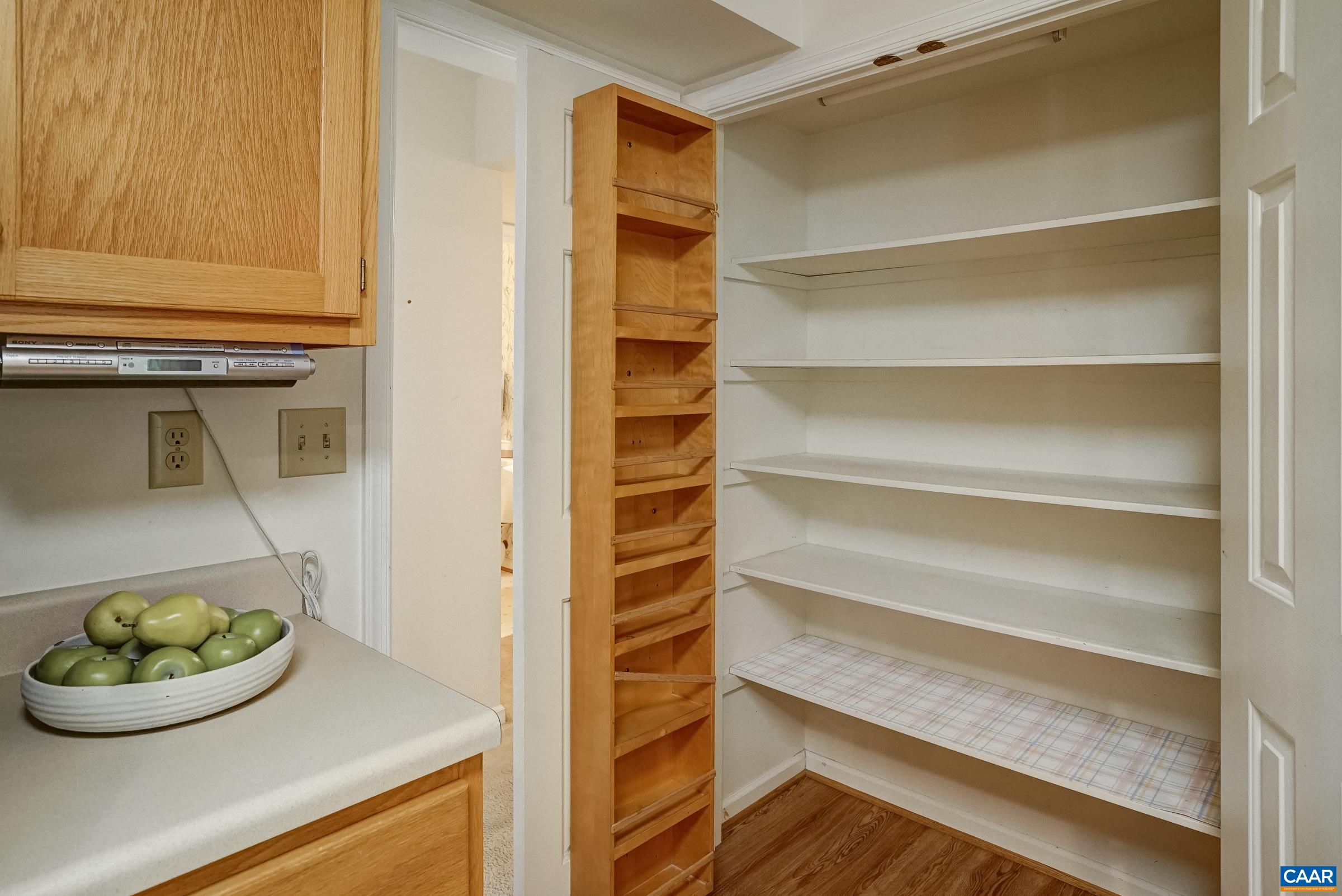 Large pantry with spice rack storage. Large pantry with spice rack storage.