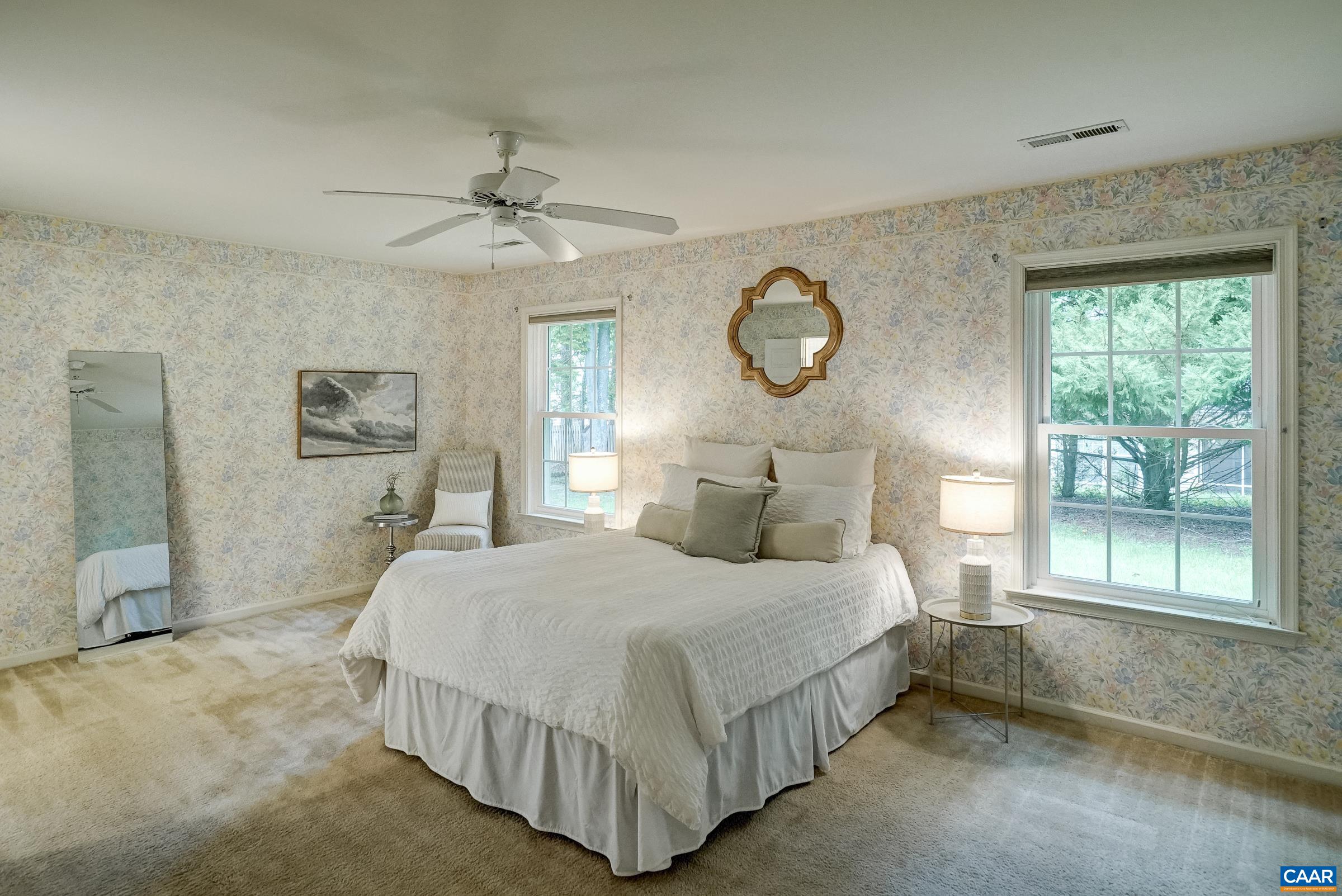 Main level primary bedroom with ceiling fan. Main level primary bedroom with ceiling fan.