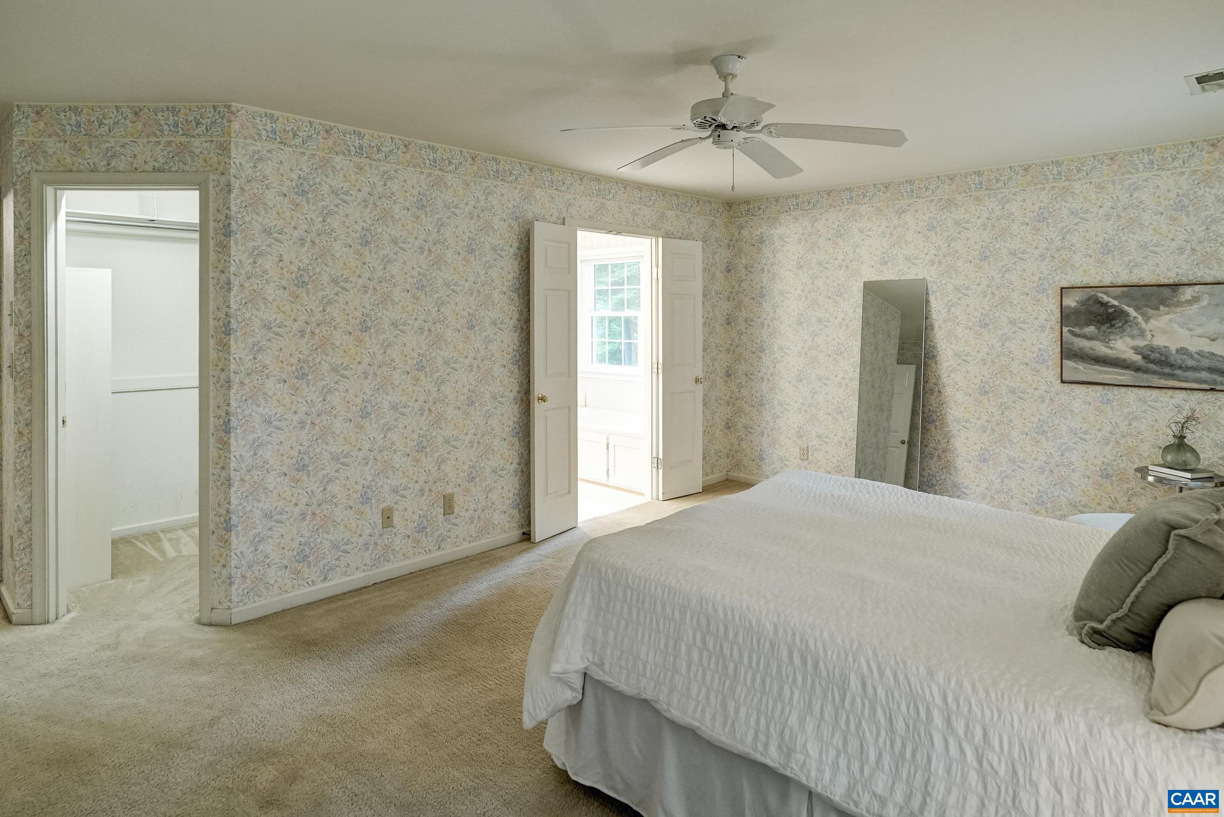 Primary bedroom with walk in closet and ensuite bathroom Primary bedroom with walk in closet and ensuite bathroom