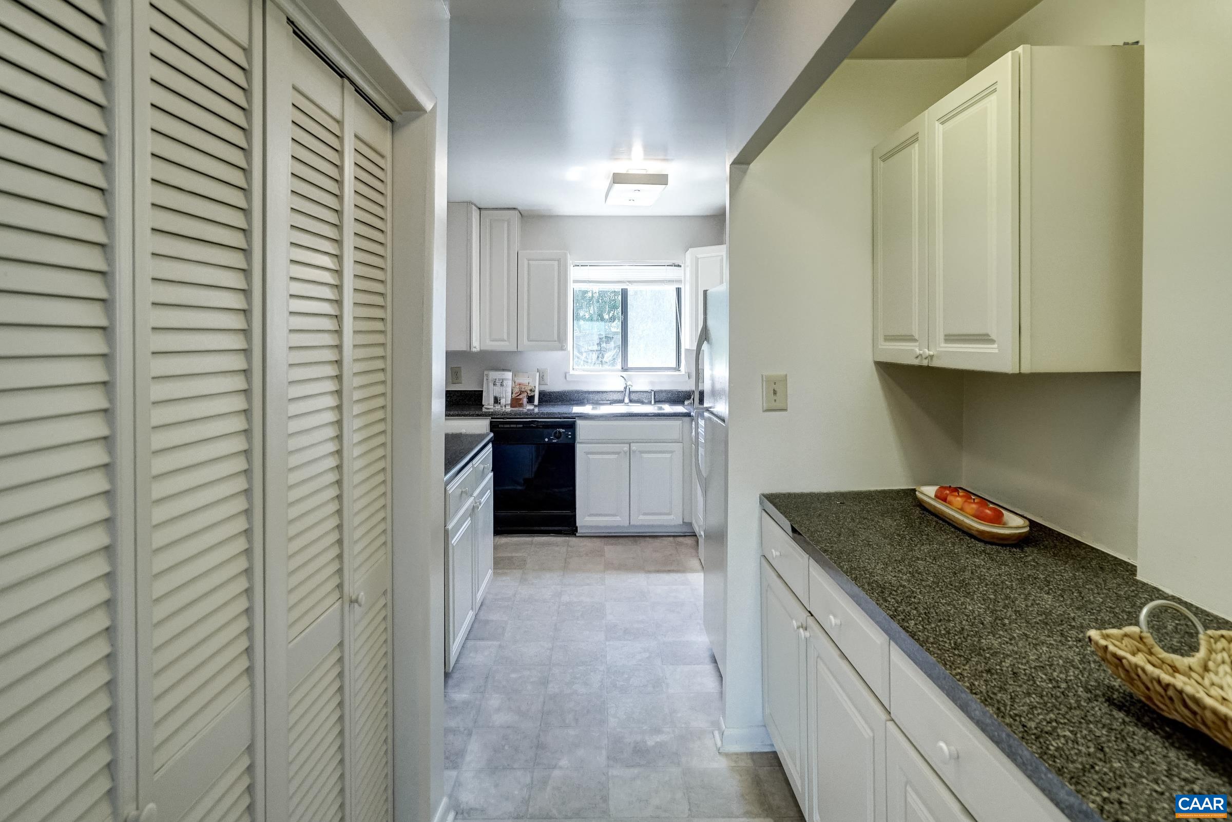 Practical kitchen features white cabinets.