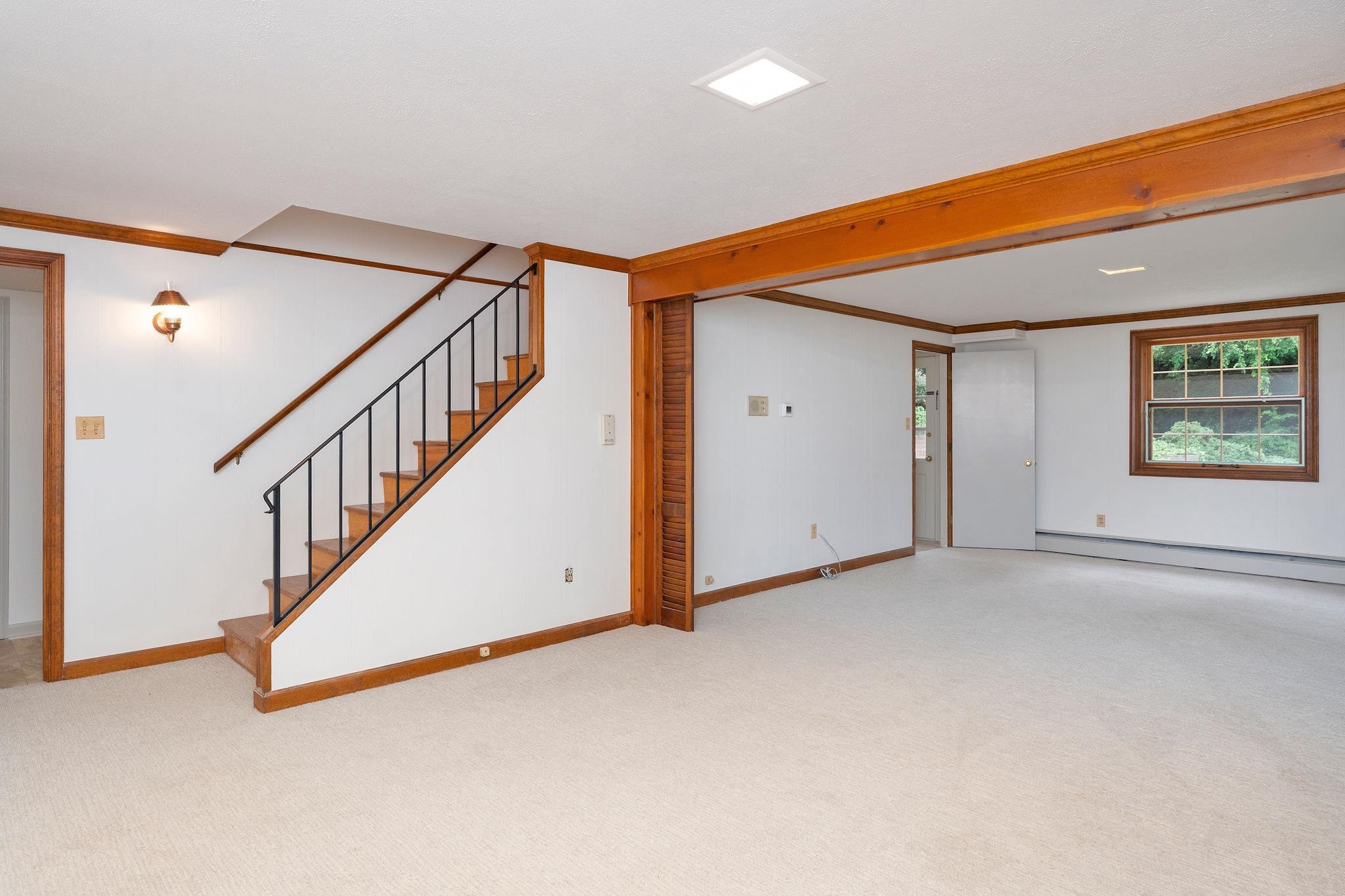 Stair access from Kitchen. Large family/rec room with windows and walk-out to back patio.