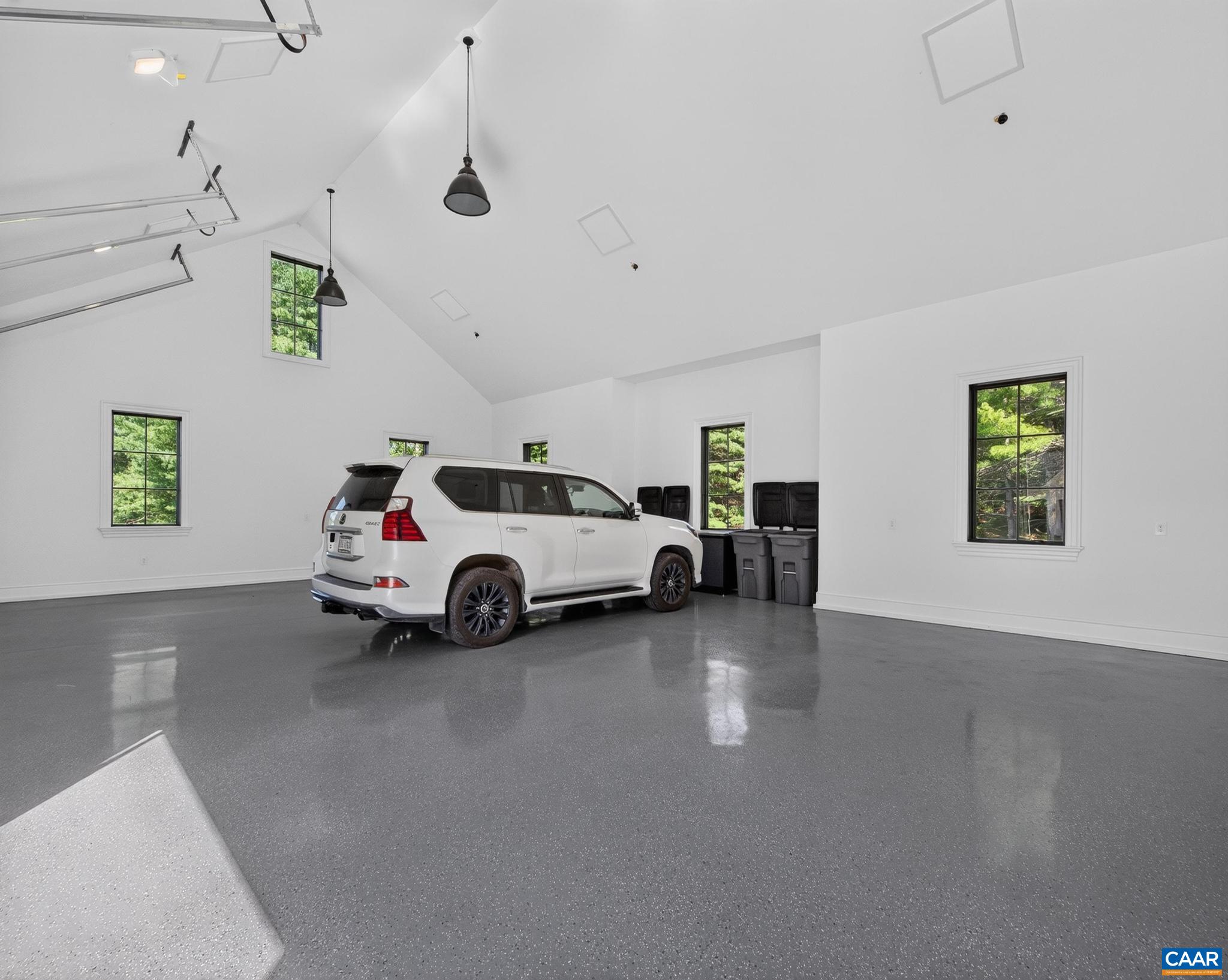 6 vaulted garage bays, 3 attached for vehicles and 3 detached for equipment or more vehicles. Epoxy floors. 6 vaulted garage bays, 3 attached for vehicles and 3 detached for equipment or more vehicles. Epoxy floors.