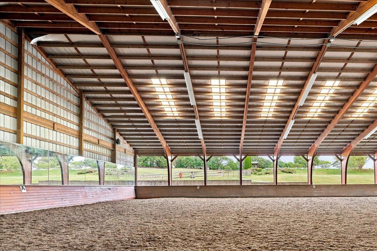 Approximately 14,400 sq. ft., with an additional 4' overhang. Constructed in 2005, the arena features a laminated wood beam structure with aluminum siding along one long wall and one end wall. The riding surface consists of crusher run/sand/Trutex Approximately 14,400 sq. ft., with an additional 4' overhang. Constructed in 2005, the arena features a laminated wood beam structure with aluminum siding along one long wall and one end wall. The riding surface consists of crusher run/sand/Trutex