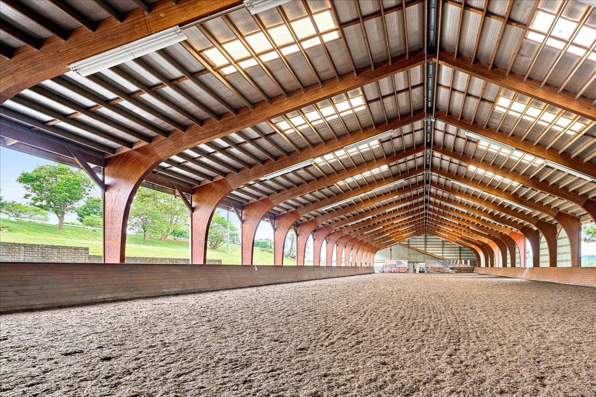 Approximately 14,400 sq. ft., with an additional 4' overhang. Constructed in 2005, the arena features a laminated wood beam structure with aluminum siding along one long wall and one end wall. The riding surface consists of crusher run/sand/Trutex Approximately 14,400 sq. ft., with an additional 4' overhang. Constructed in 2005, the arena features a laminated wood beam structure with aluminum siding along one long wall and one end wall. The riding surface consists of crusher run/sand/Trutex