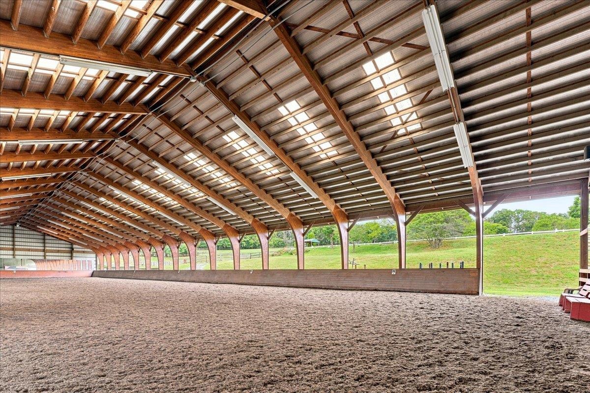 Approximately 14,400 sq. ft., with an additional 4' overhang. Constructed in 2005, the arena features a laminated wood beam structure with aluminum siding along one long wall and one end wall. The riding surface consists of crusher run/sand/Trutex Approximately 14,400 sq. ft., with an additional 4' overhang. Constructed in 2005, the arena features a laminated wood beam structure with aluminum siding along one long wall and one end wall. The riding surface consists of crusher run/sand/Trutex