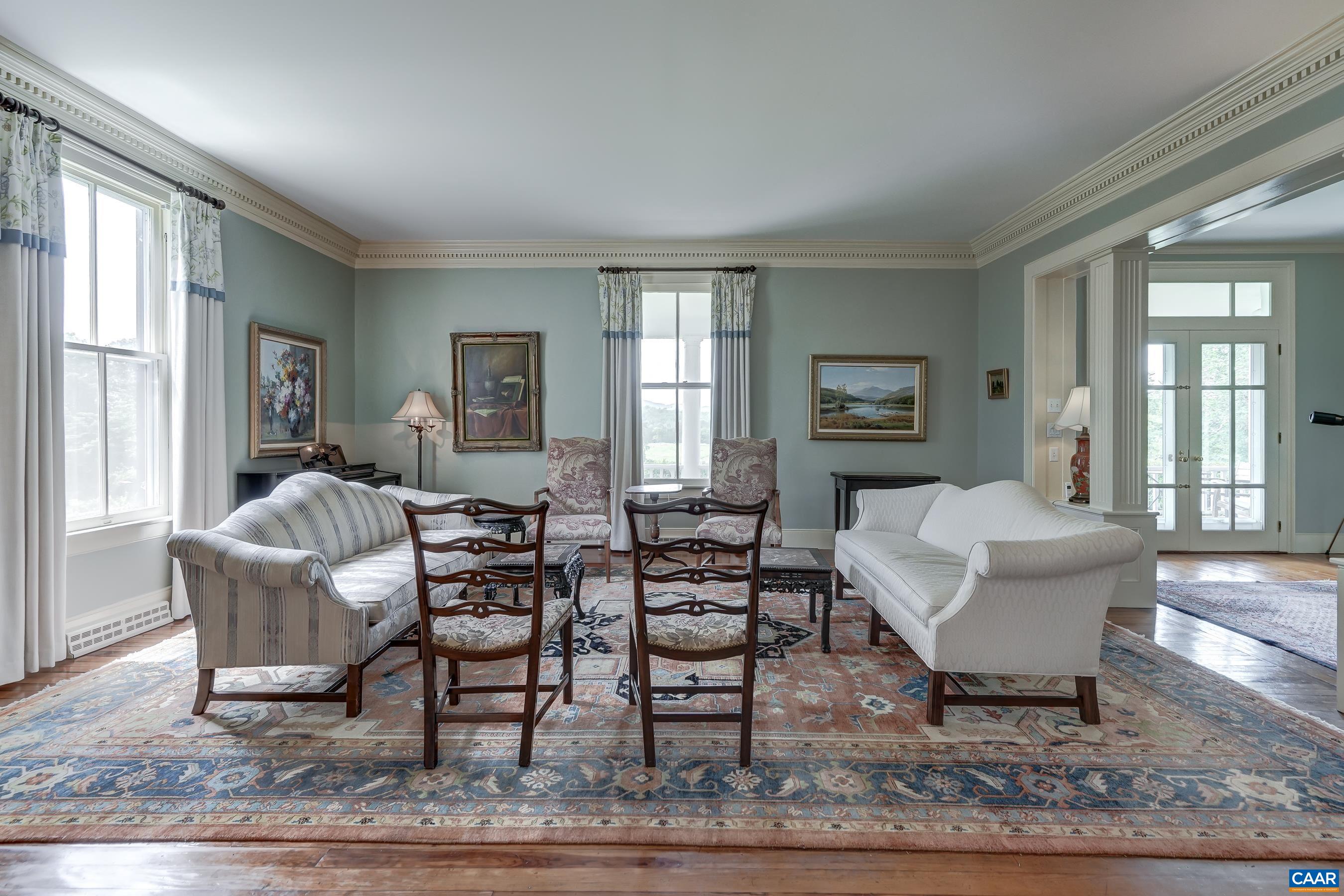 Formal living room with ornate trim details, built-in china cabinets.