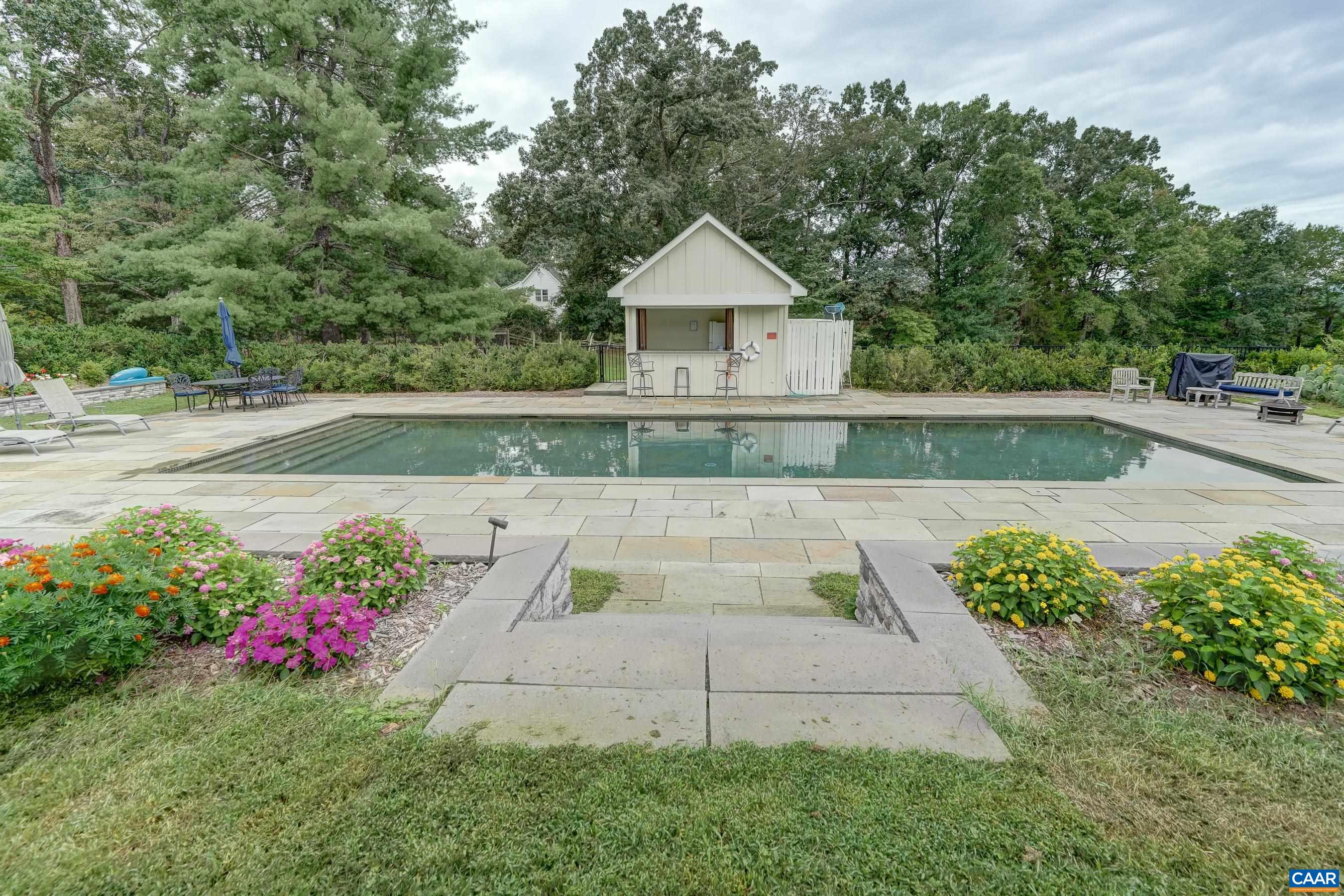 Beautiful pool surrounded by colorful gardens