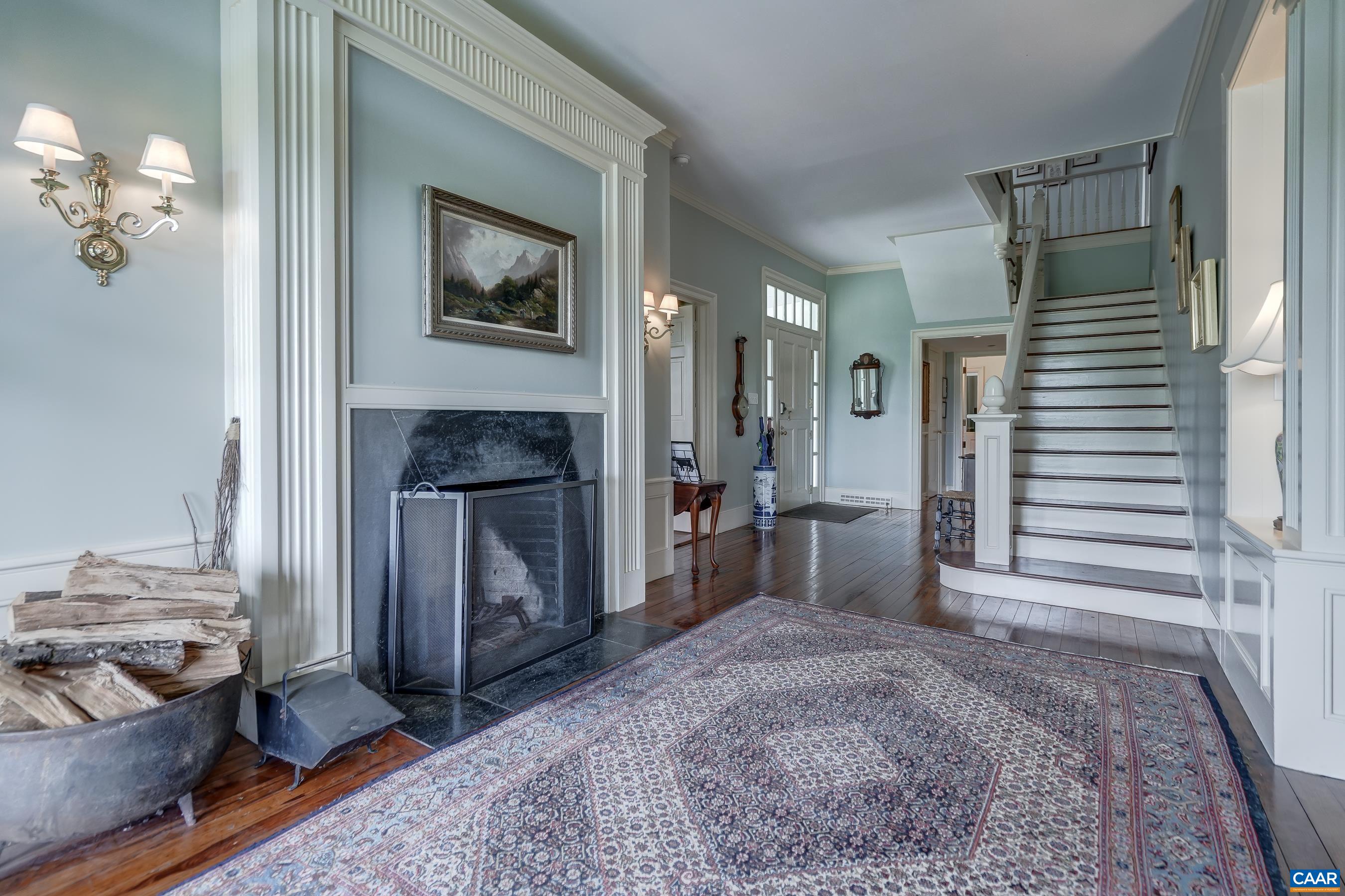 Stunning foyer welcomes you into the main house with original wood burning fireplaces and restored heart of pine floors.