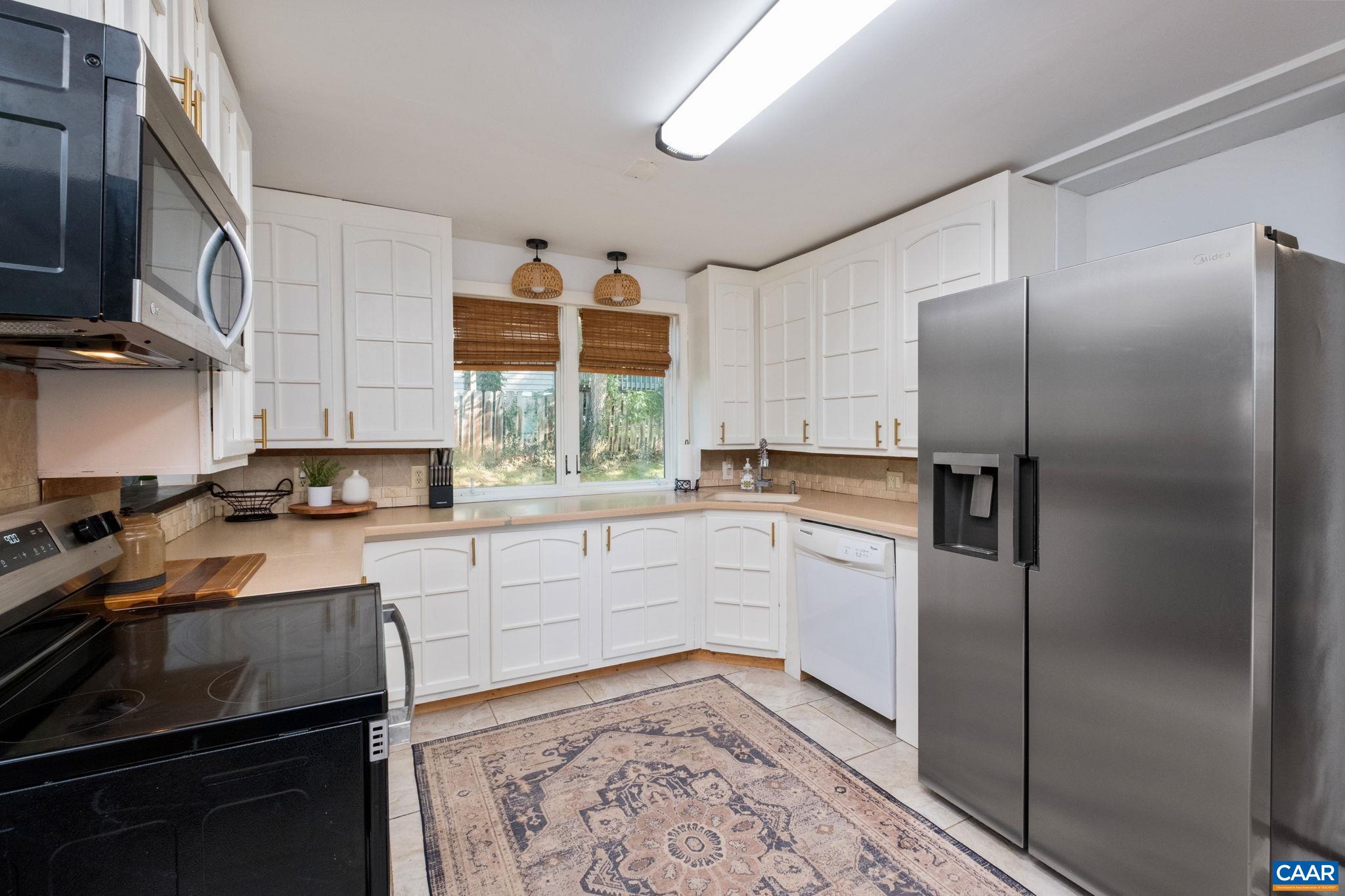 Kitchen remodeled in 2024 features new white cabinets, new stainless appliances and solid surface coutnertops. Kitchen remodeled in 2024 features new white cabinets, new stainless appliances and solid surface coutnertops.