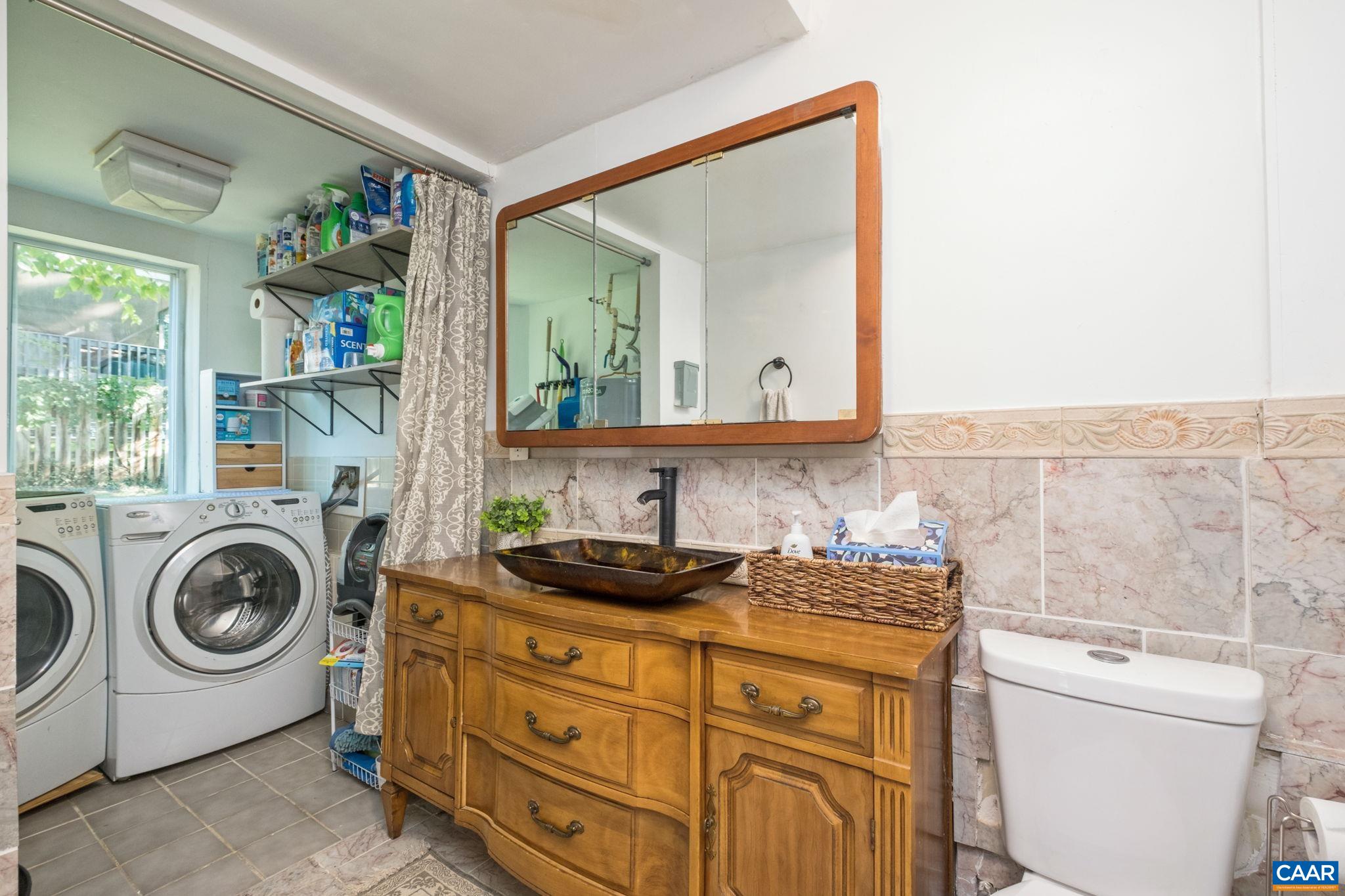 Half bathroom includes laundry area. Half bathroom includes laundry area.